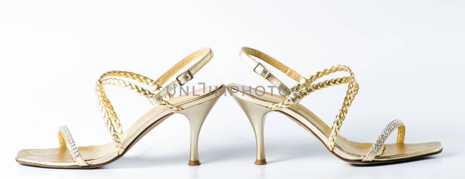 Woman golden shoes on white by marius_dragne