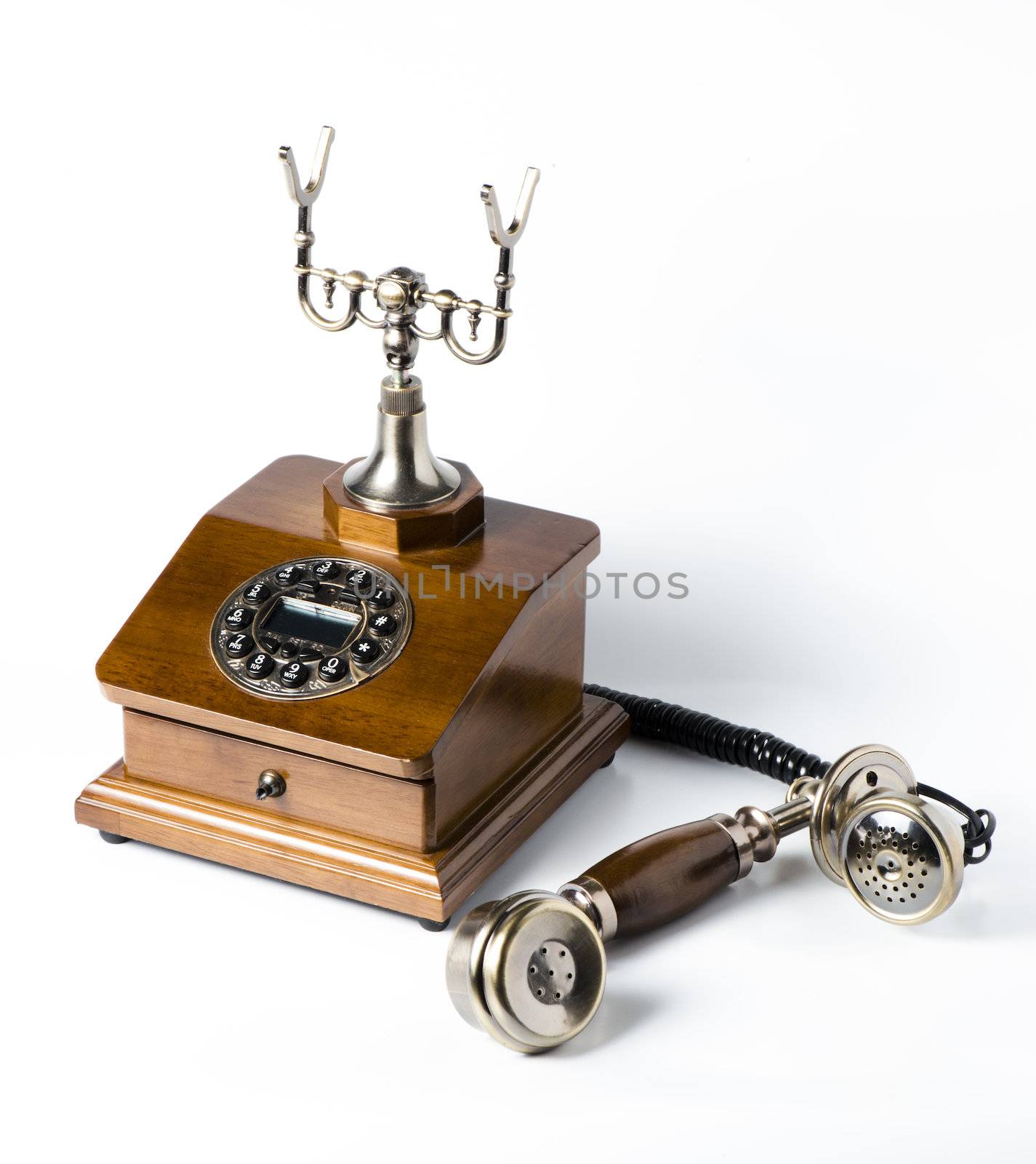 Old wooden phone on white by marius_dragne