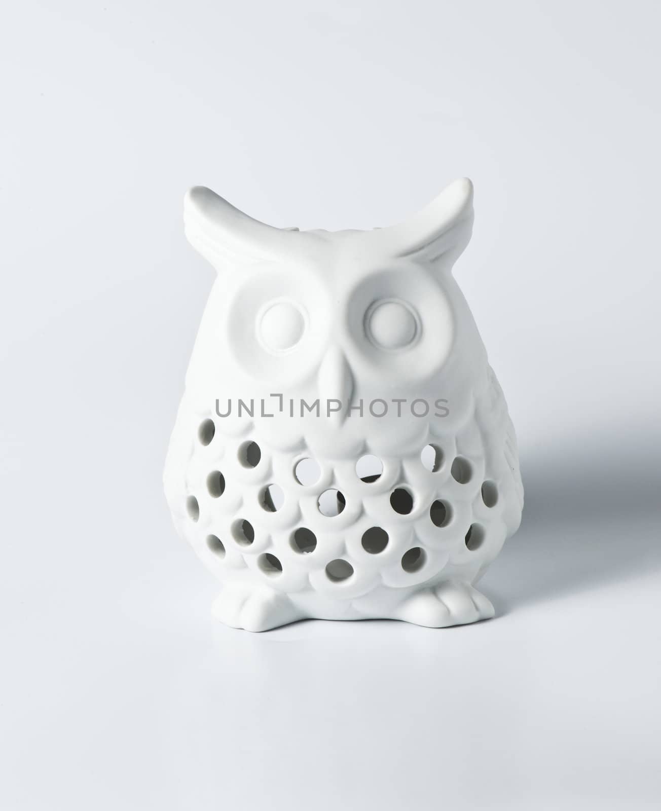 White ceramic owl for decoration on white