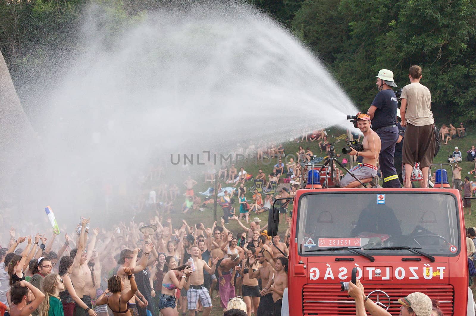 OZORA, HUNGARY - AUGUST 01: Fire department spray water on crowd by anderm