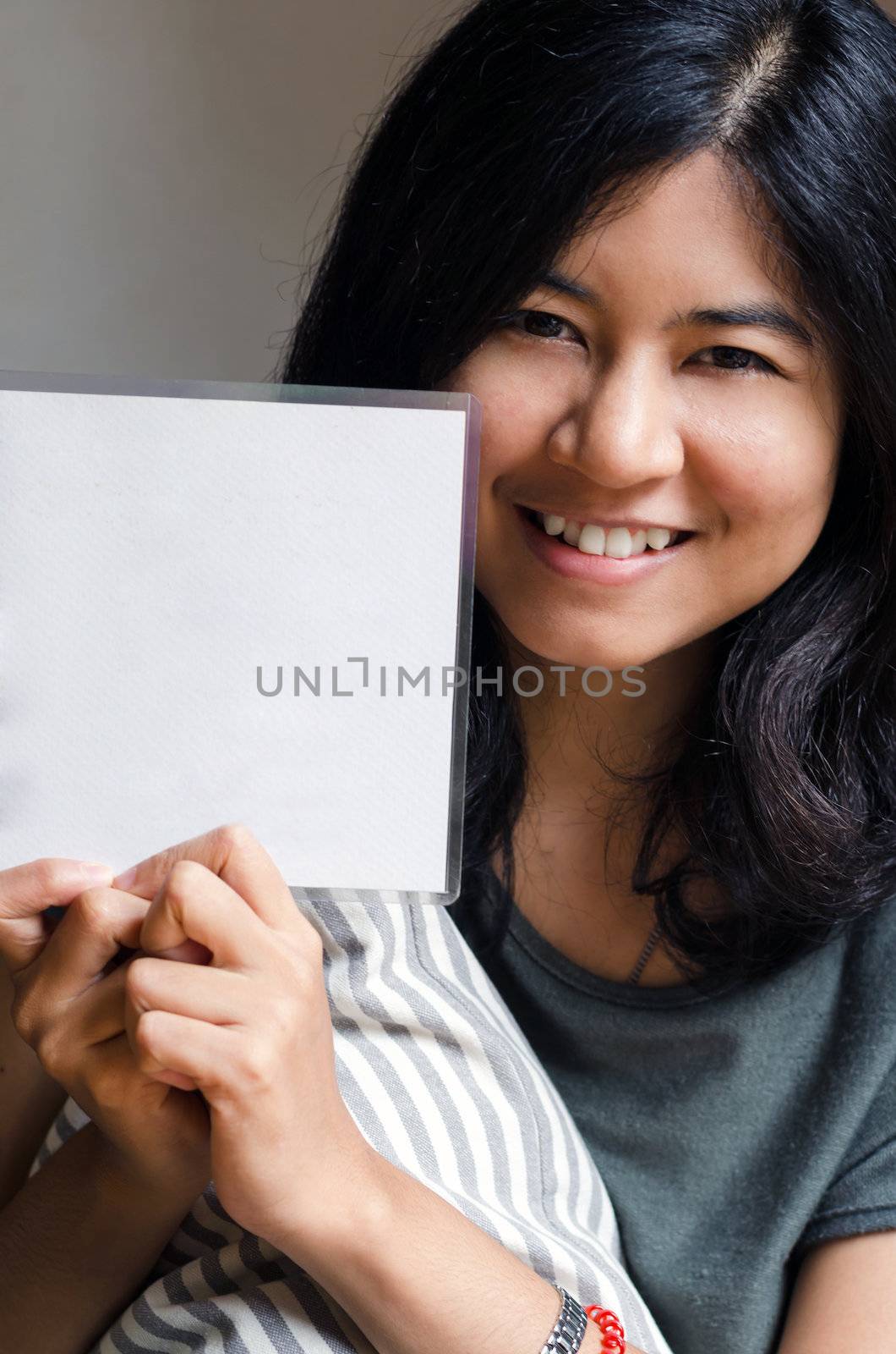 Woman hold white blank board by siraanamwong