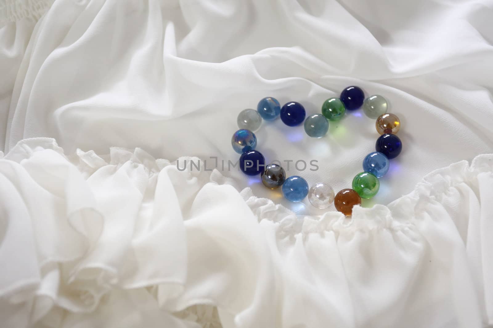 There are many glass balls are arrange be the "Heart" on the part of bridal gown.