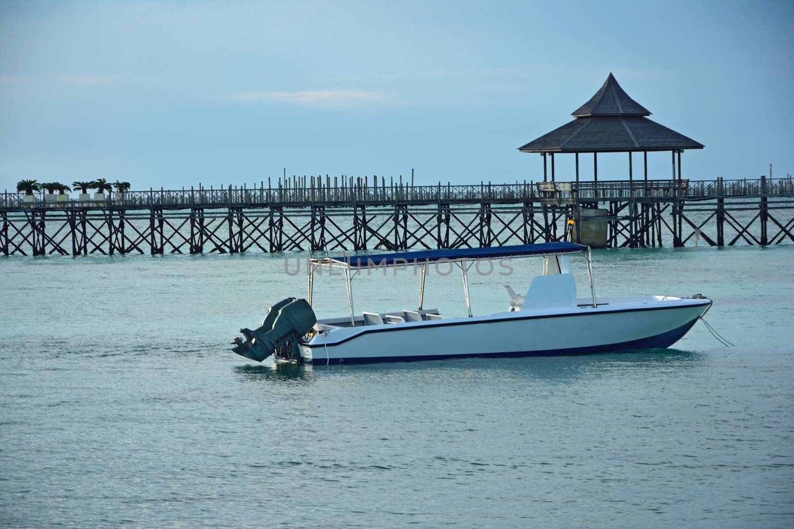 boat on crystal water, sipadan borneo malaysia by think4photop