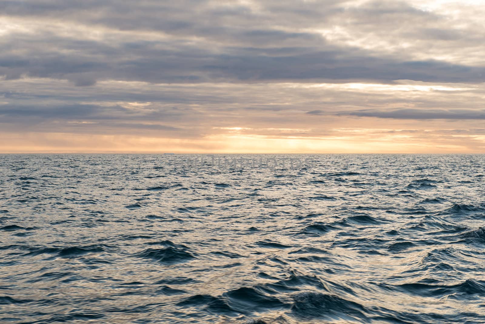 Beautiful ocean landscape in the arctic with an intense cloud pattern and sun light