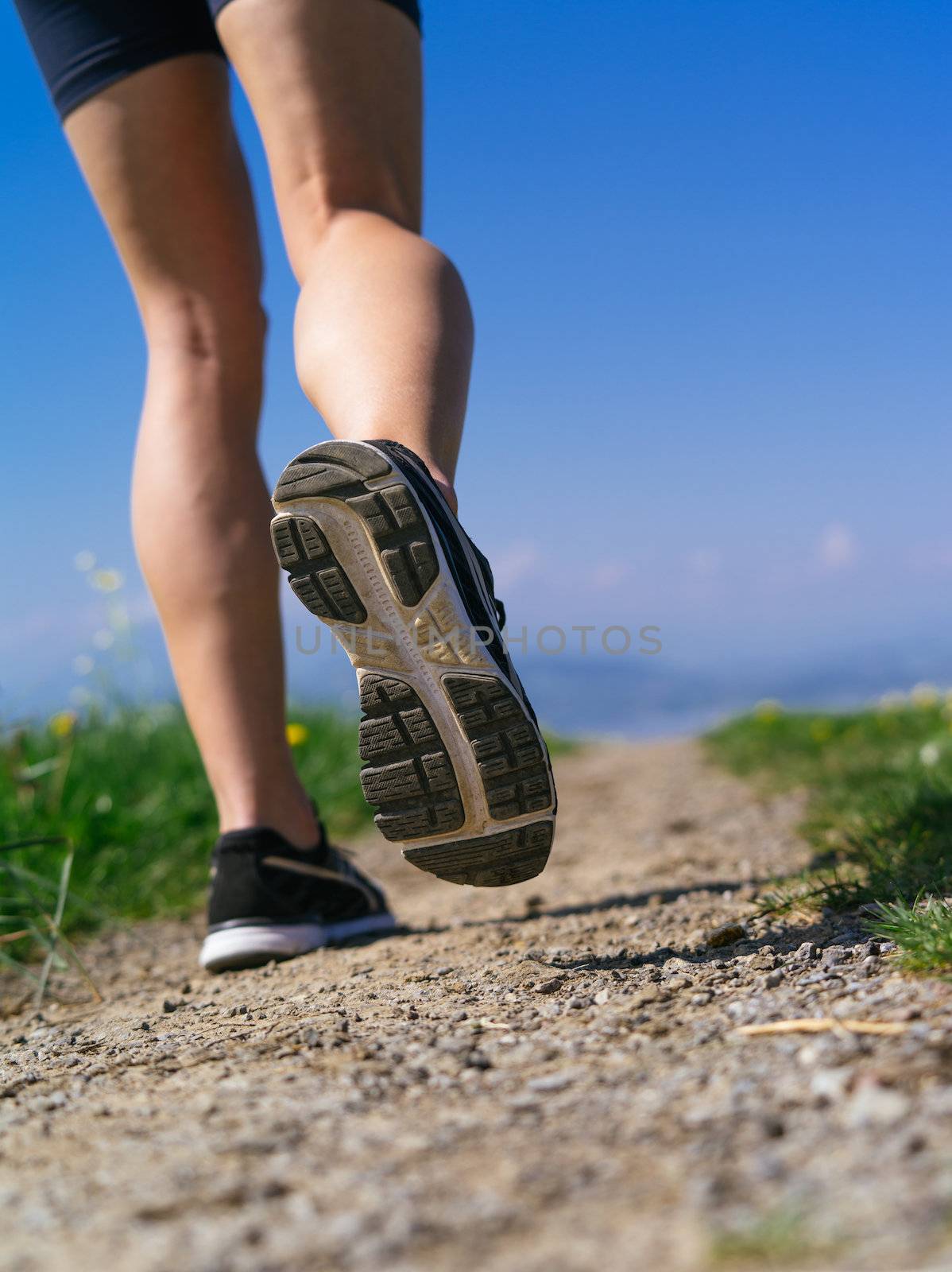 Legs and shoes of a woman jogger by sumners