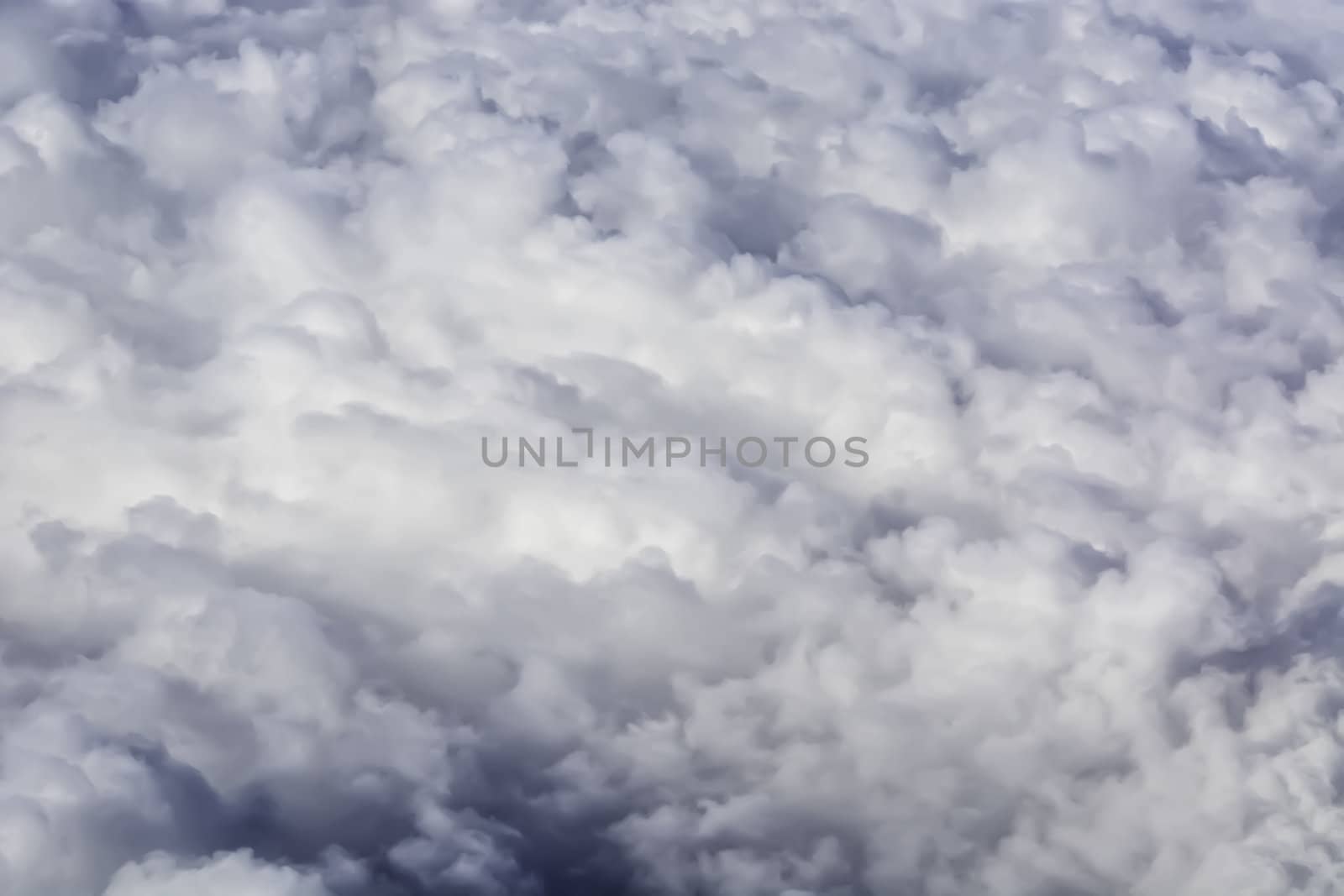 Fluffy rain clouds shot from an airplane