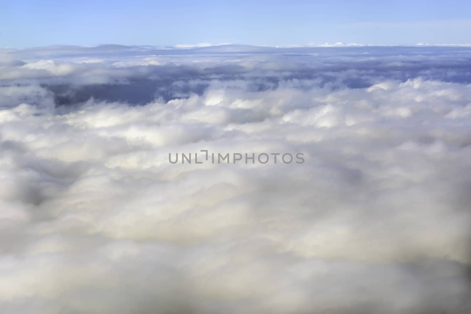 Fluffy rain clouds shot from an airplane