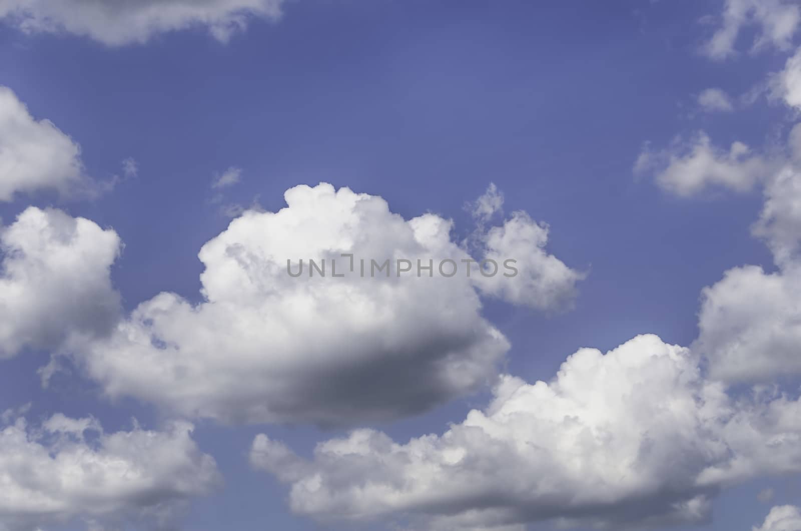 Fluffy cumulus clouds against blue sky