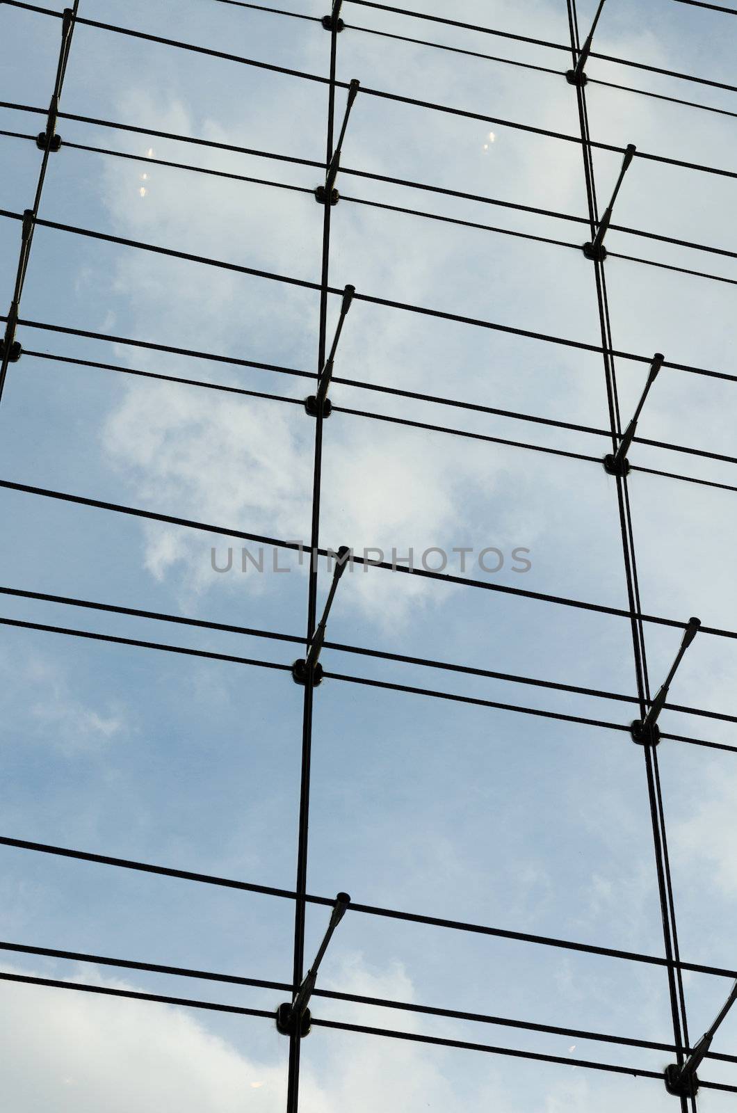 Glass curtain wall in a modern building, blue sky background