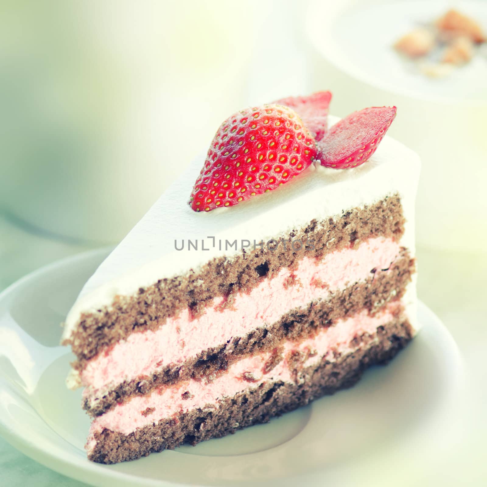 Slice of strawberry chocolate cake, in vintage retro toned with noise.