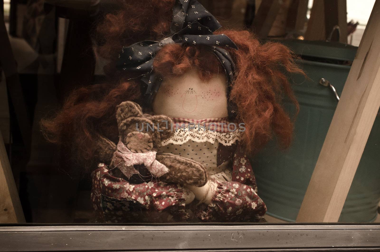 old lady doll brown hair and several small dolls .