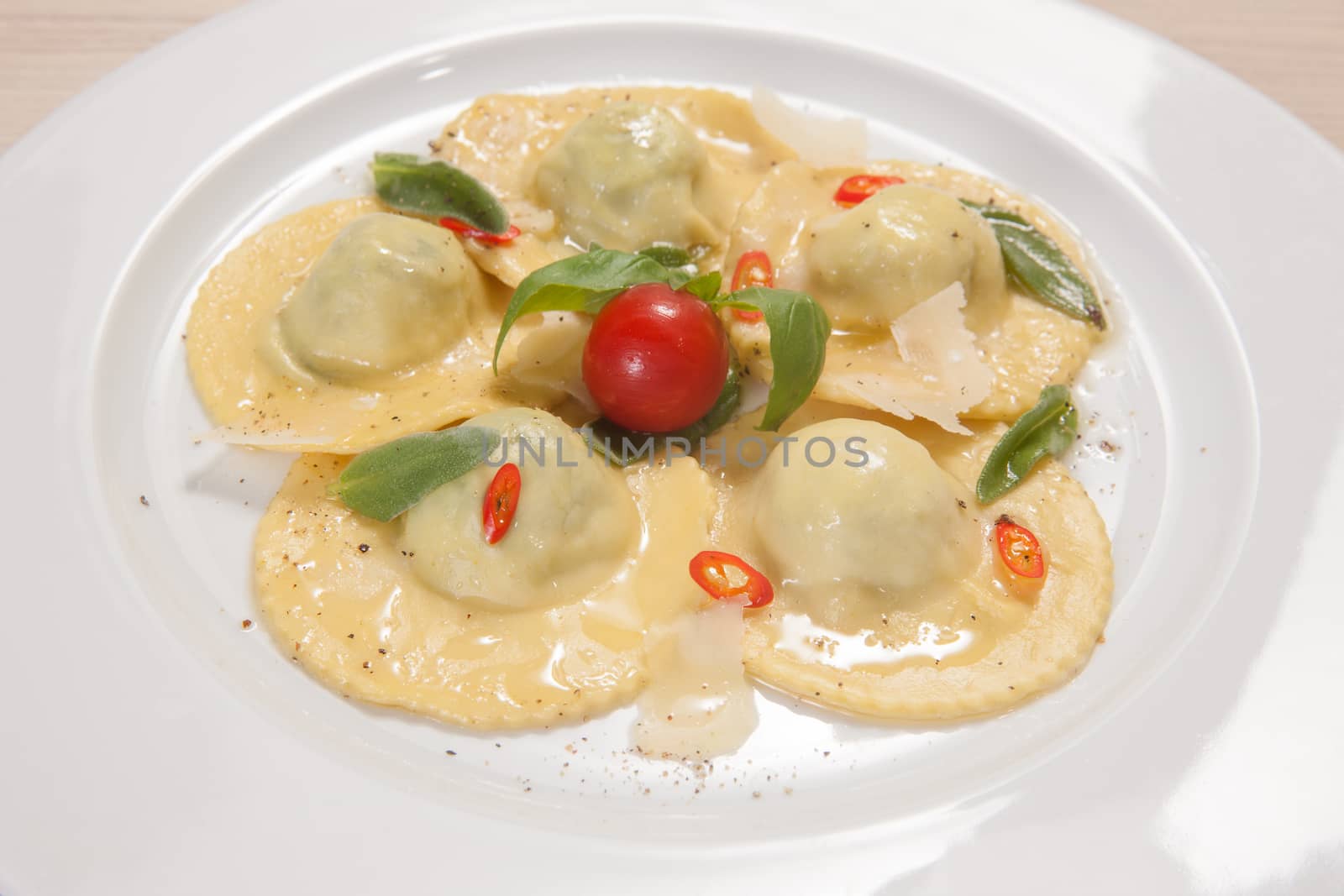 Ravioli with red chily pepper, tomato, cheese and sweet basil