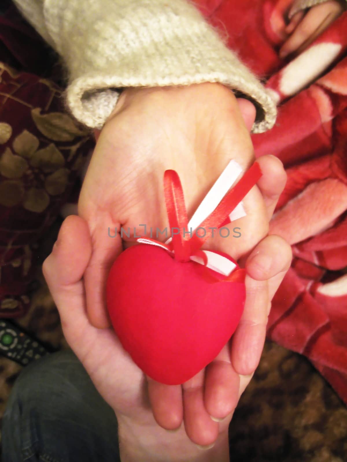 Valentine red heart in woman and man hands