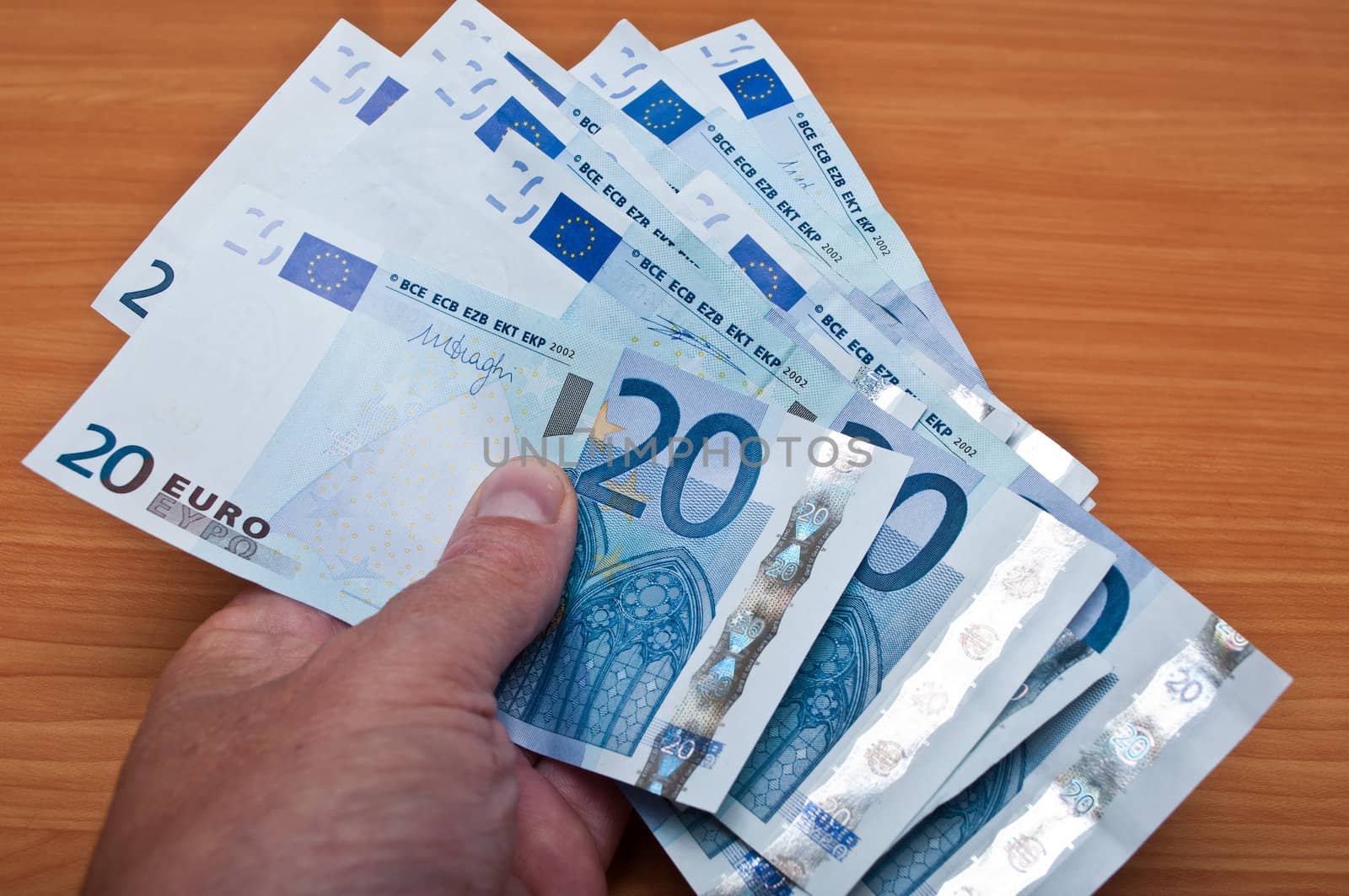 man pay with banknot of twenty euros by NeydtStock