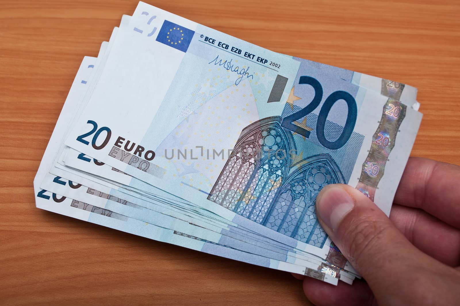 man pay with banknot of twenty euros by NeydtStock