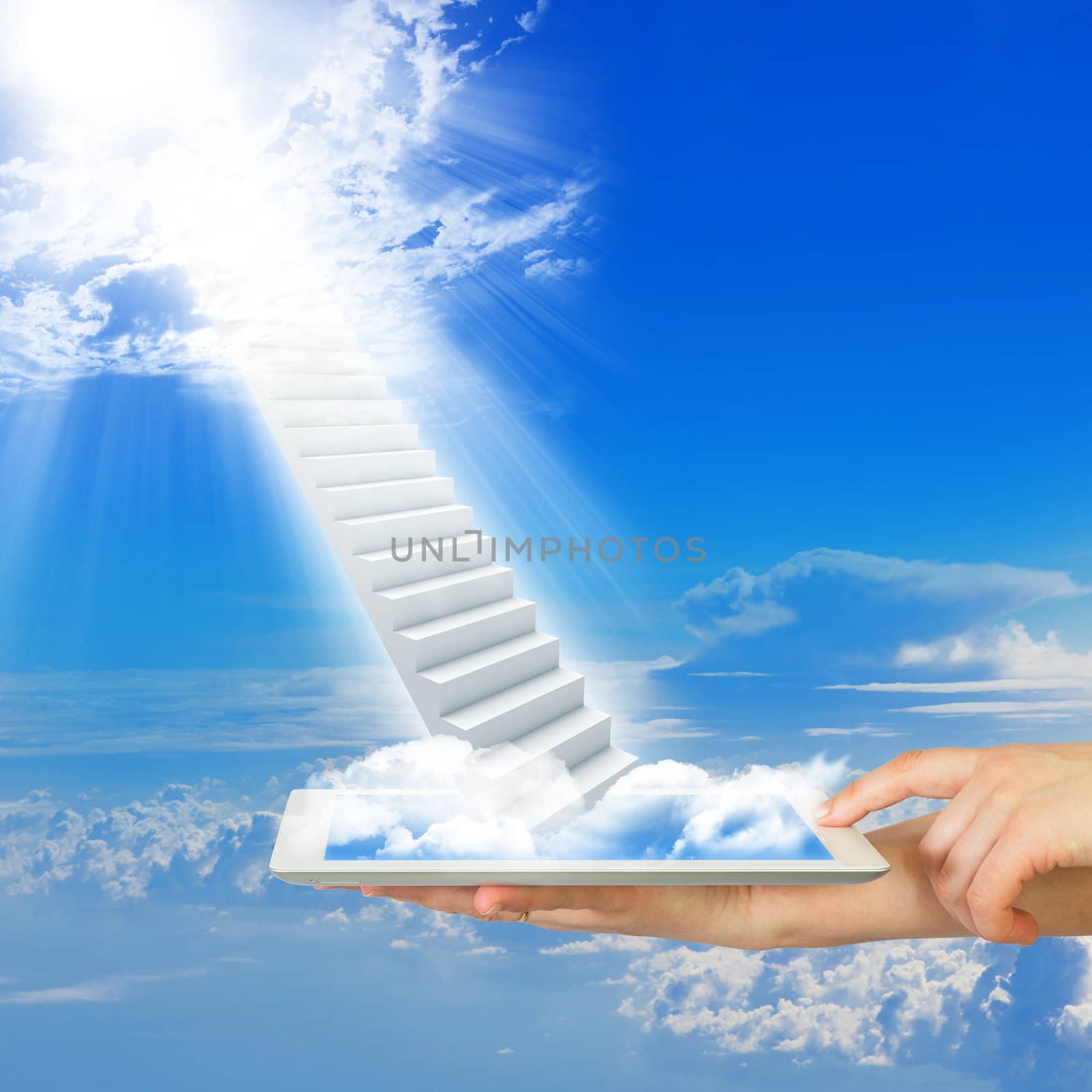 Hands hold tablet pc with stairs in sky. Clouds and sun as backdrop