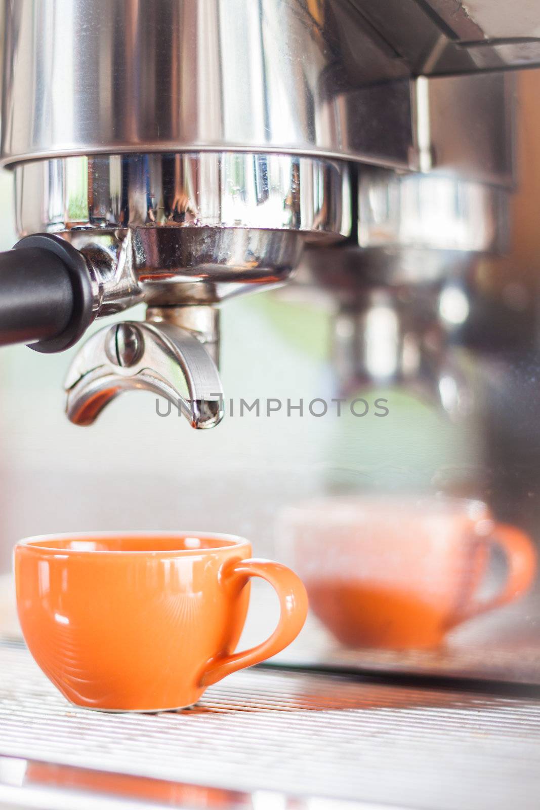 Single shot in orange cup of coffee by punsayaporn