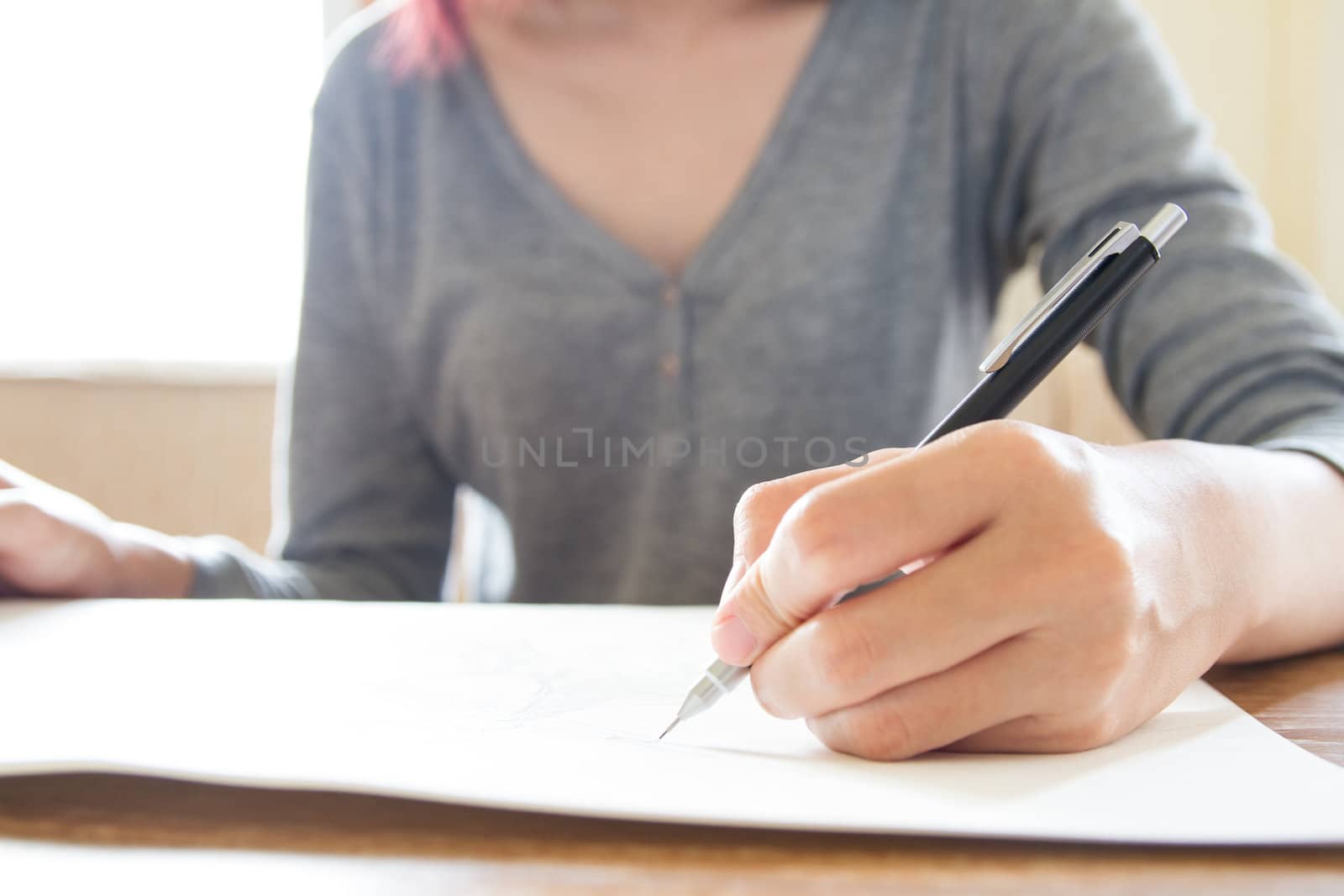 Woman hand using pencil drawing, sketching by kasinv