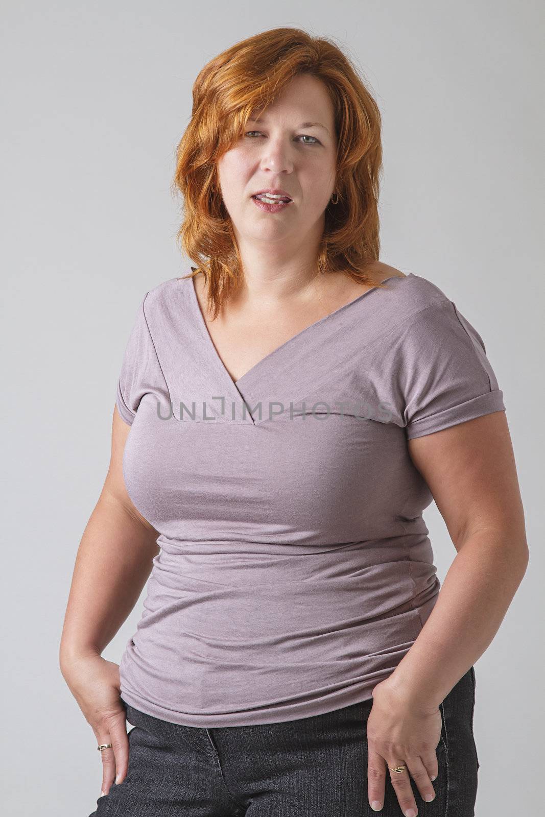 Round woman in her forties with disgusted expression