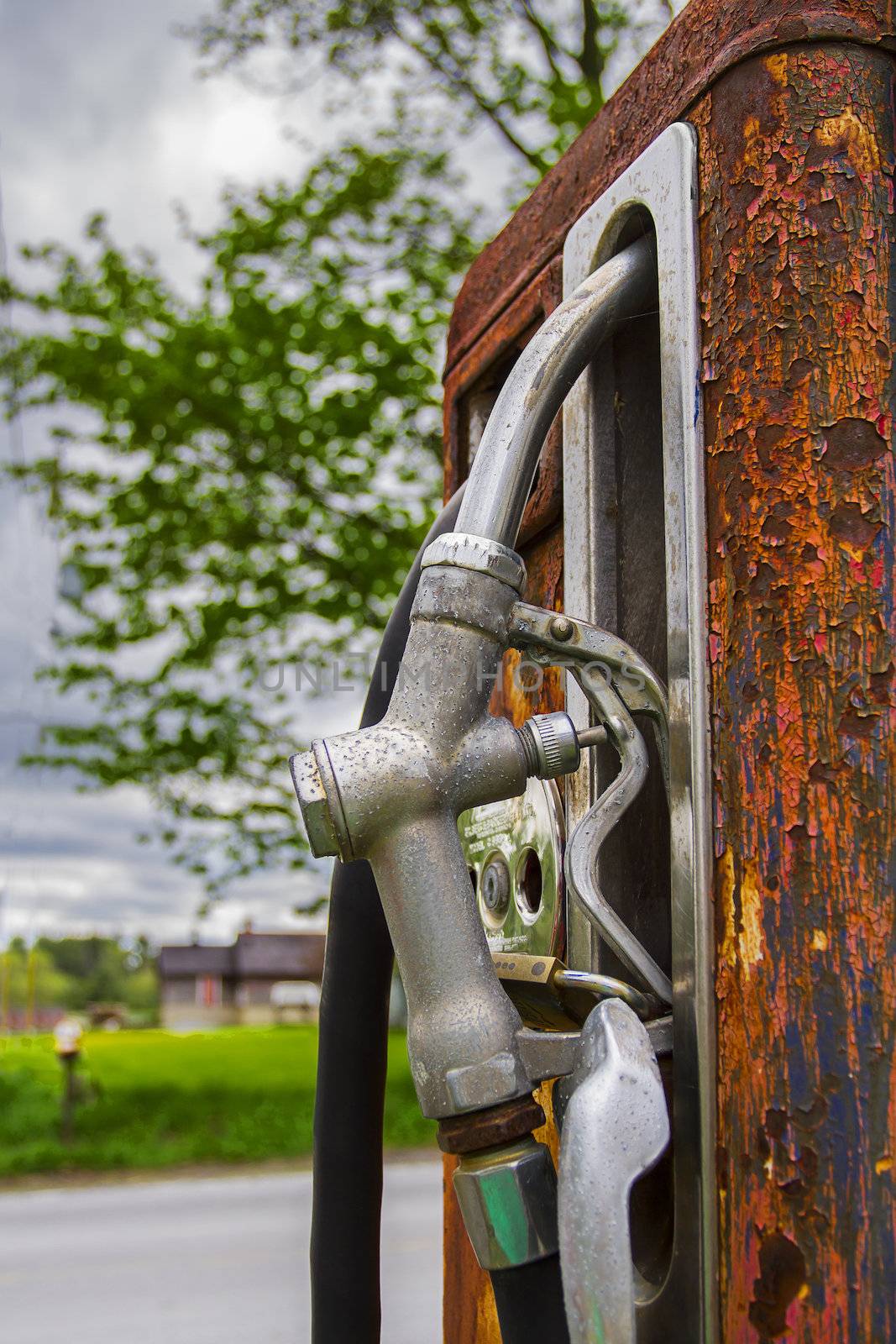 Close up view of a rusted gaz pump and nozzle