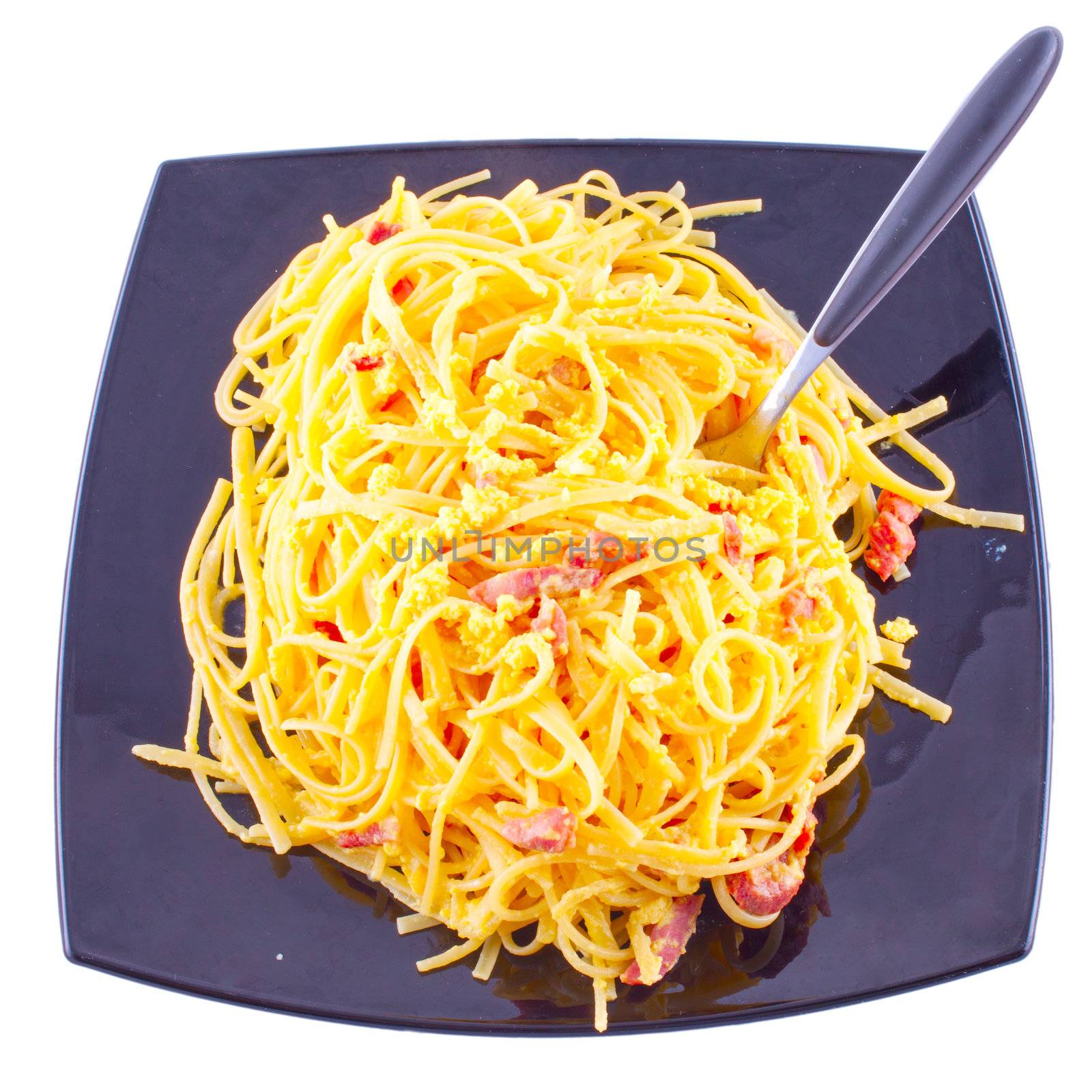 Gorgeous plate of pasta alla carbonara isolated over white