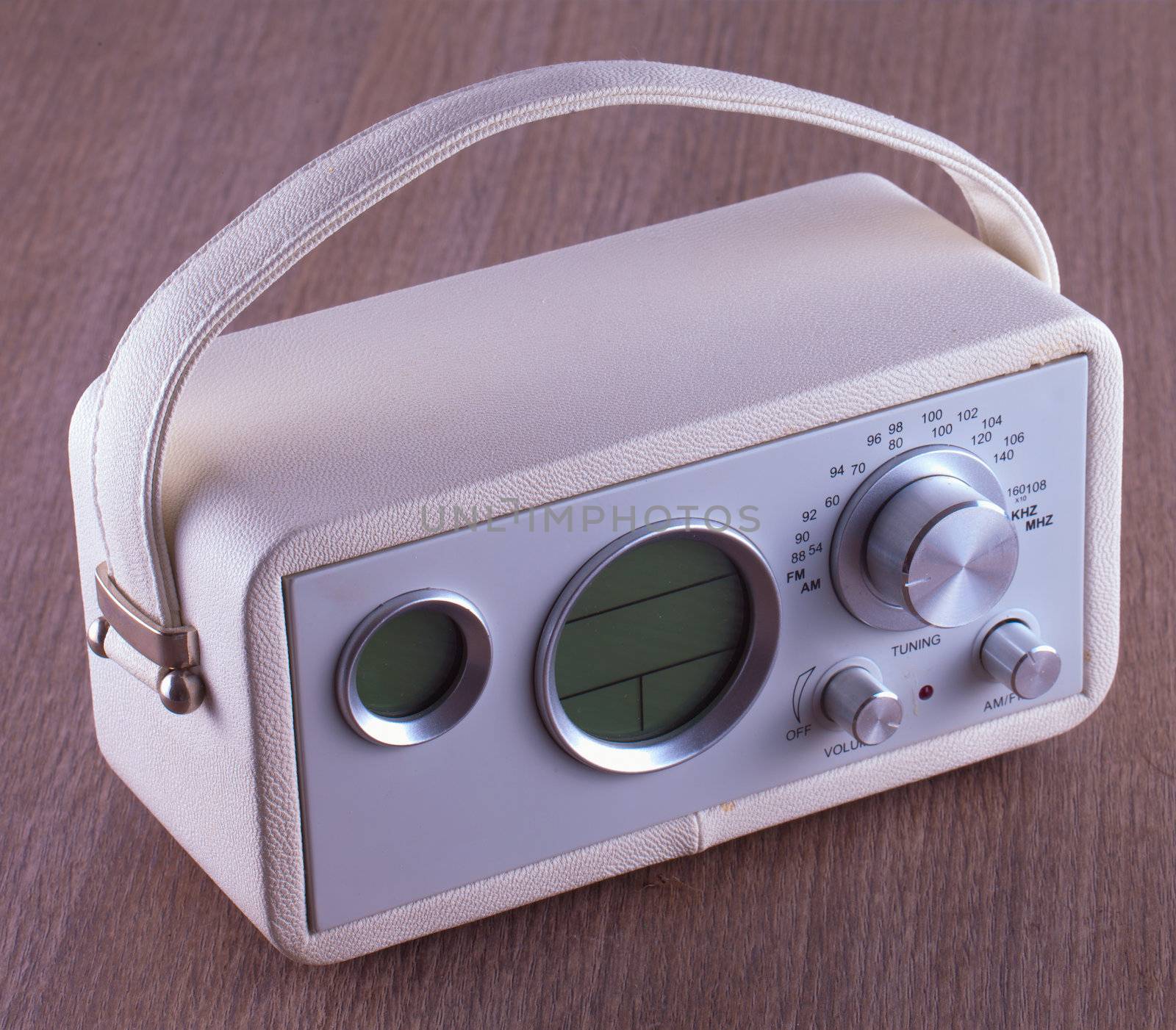 A vintage white radio over wooden table