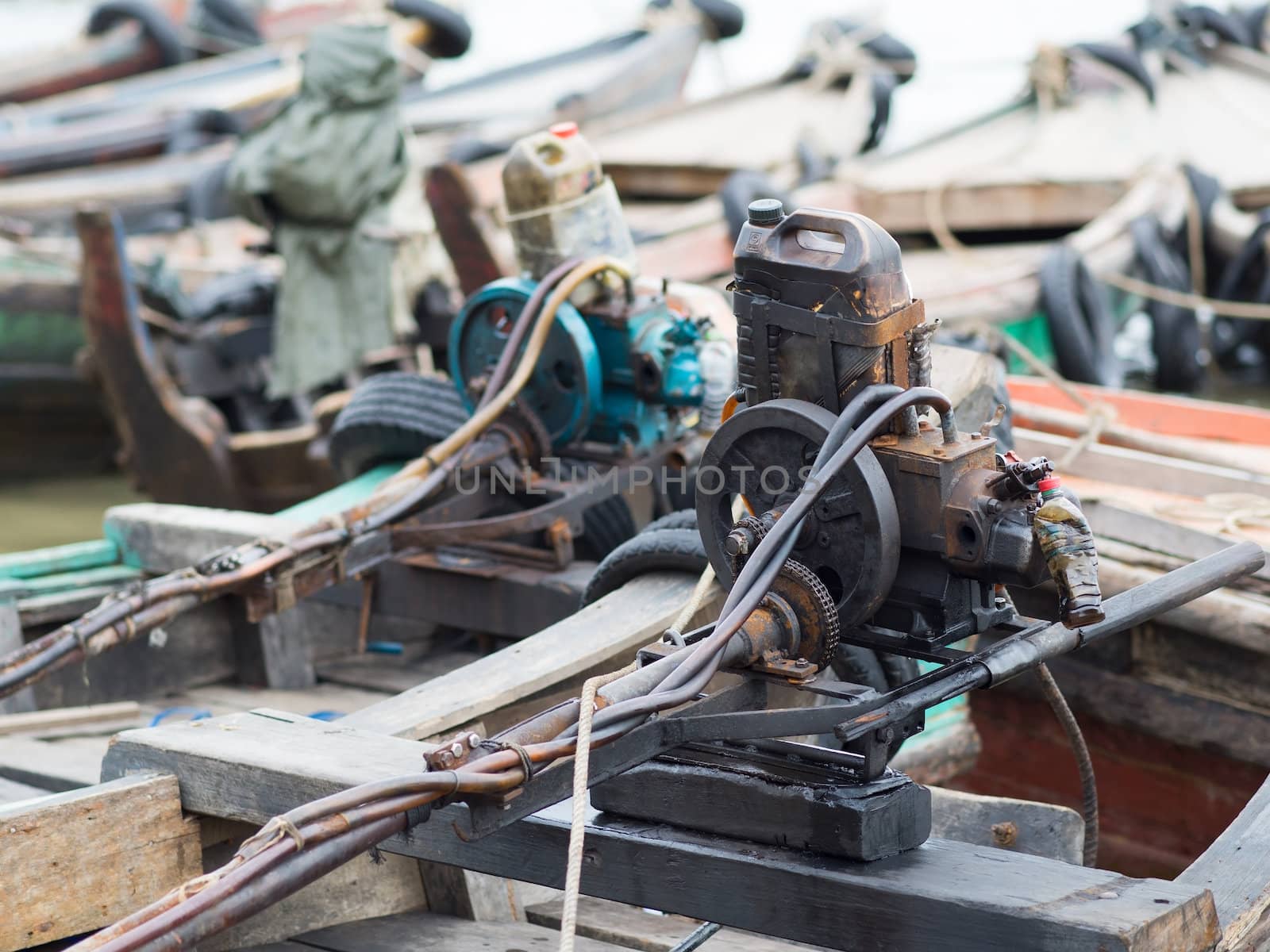 Primitive boat engines on traditional wooden boats at the harbour of Myeik in southern Myanmar.