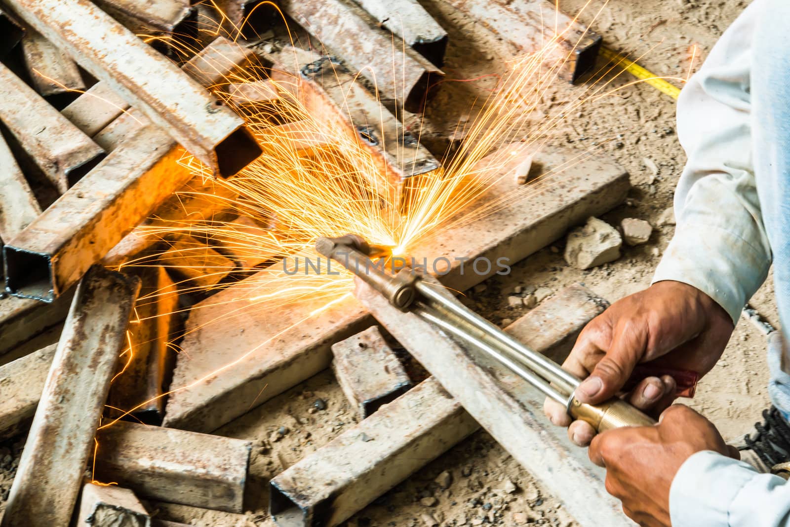 metal cutting with acetylene torch, focus on tools, low Light