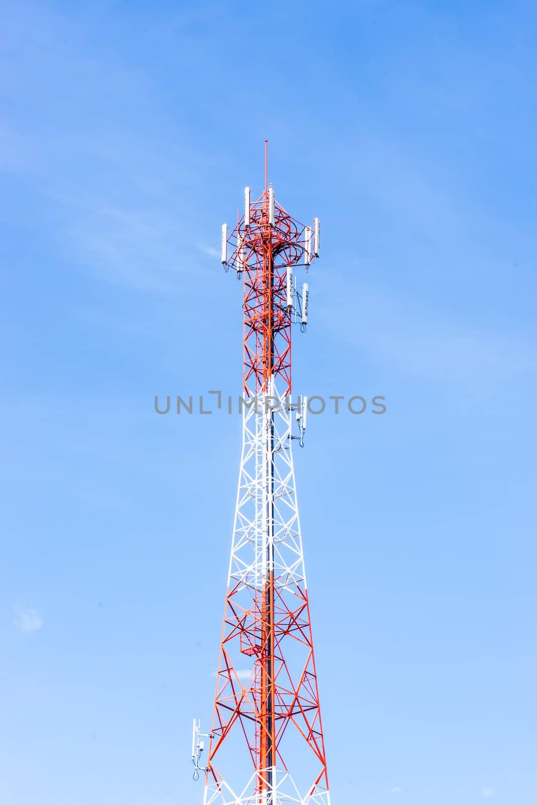 Red and white antenna on blue sky by wmitrmatr