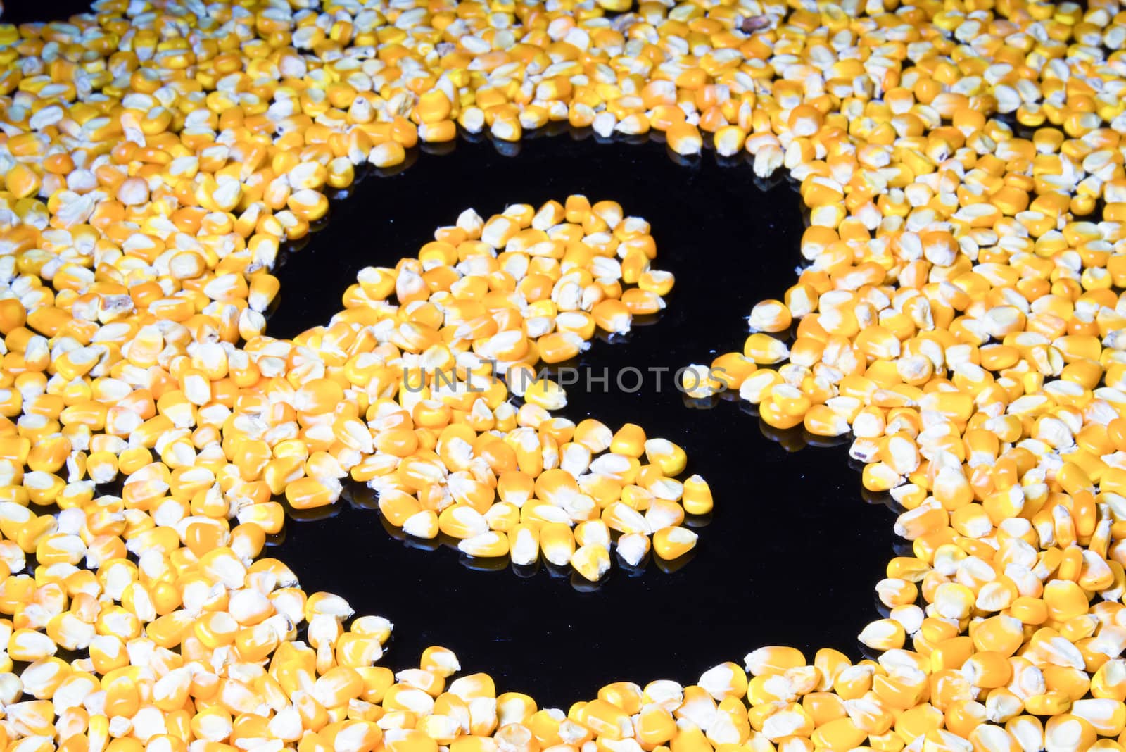 Corn made ​​the number three on a black background.