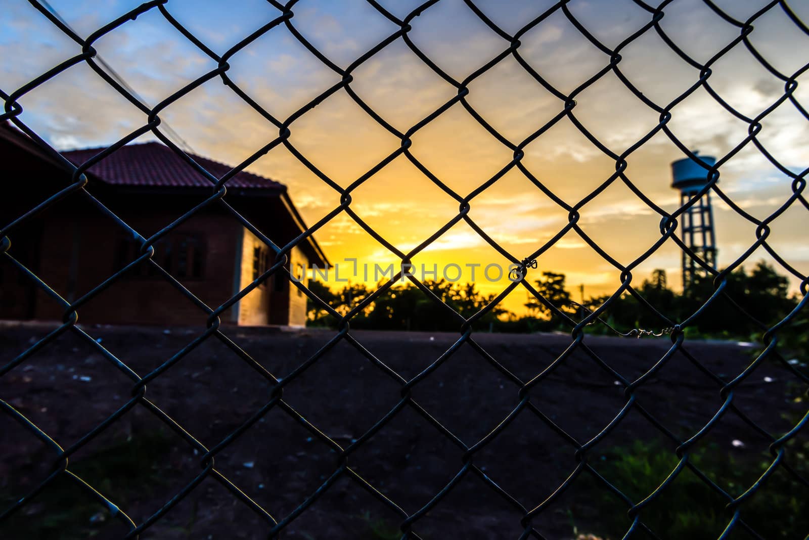 the beautiful fence mesh background with the blure sunset. by wmitrmatr