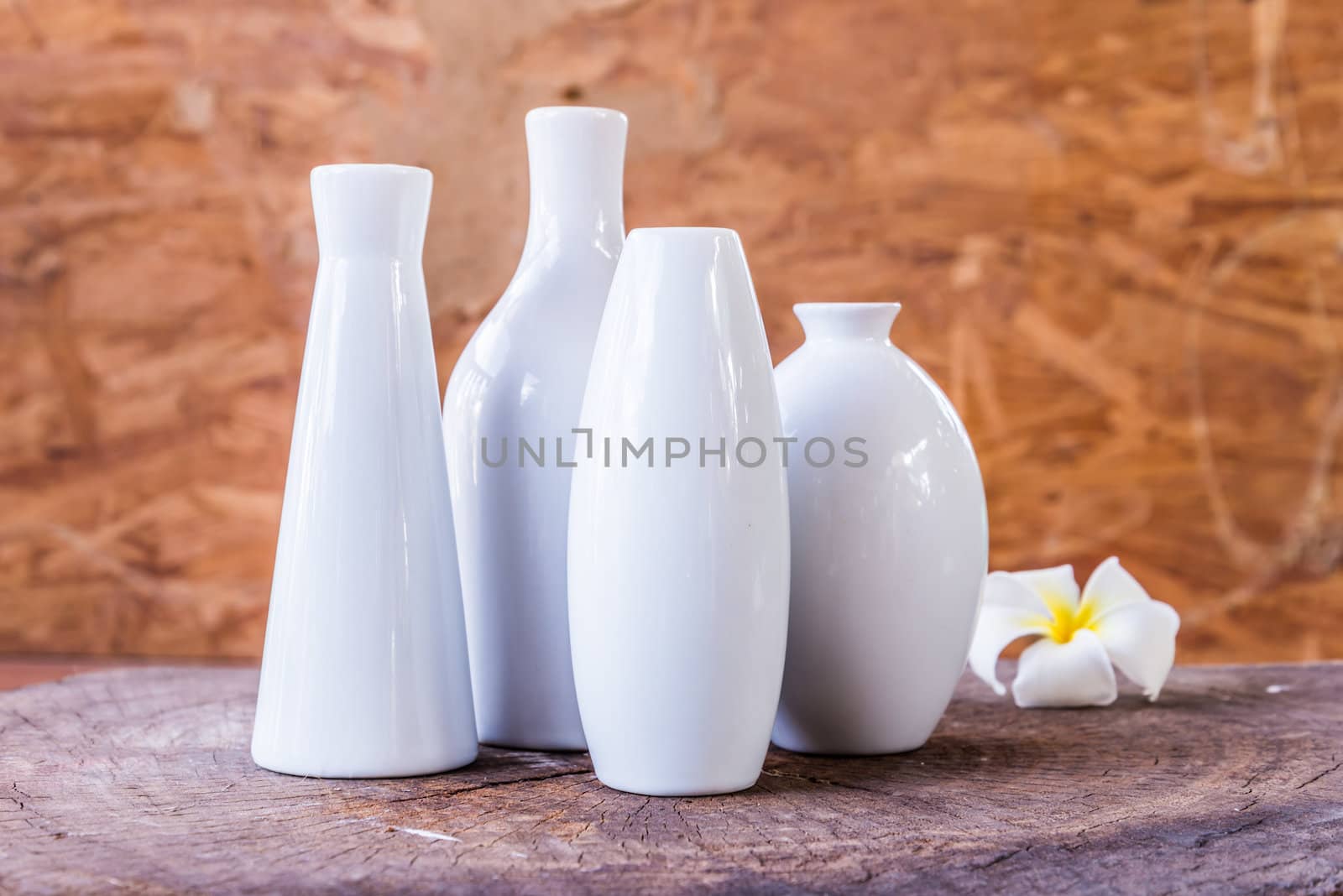 porcelain vases of various shapes on wood background
