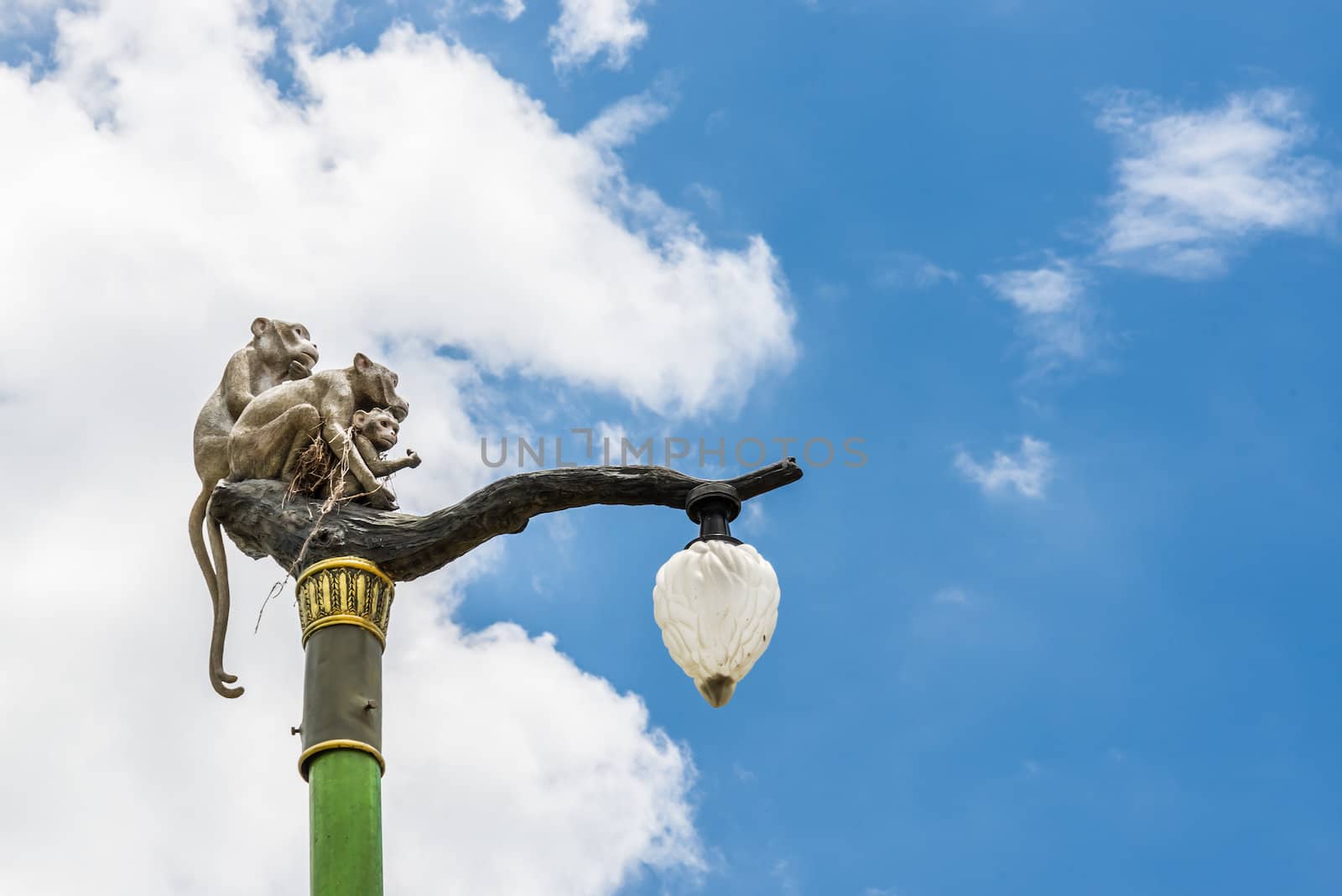 Statue of a monkey family on lamp post. by wmitrmatr