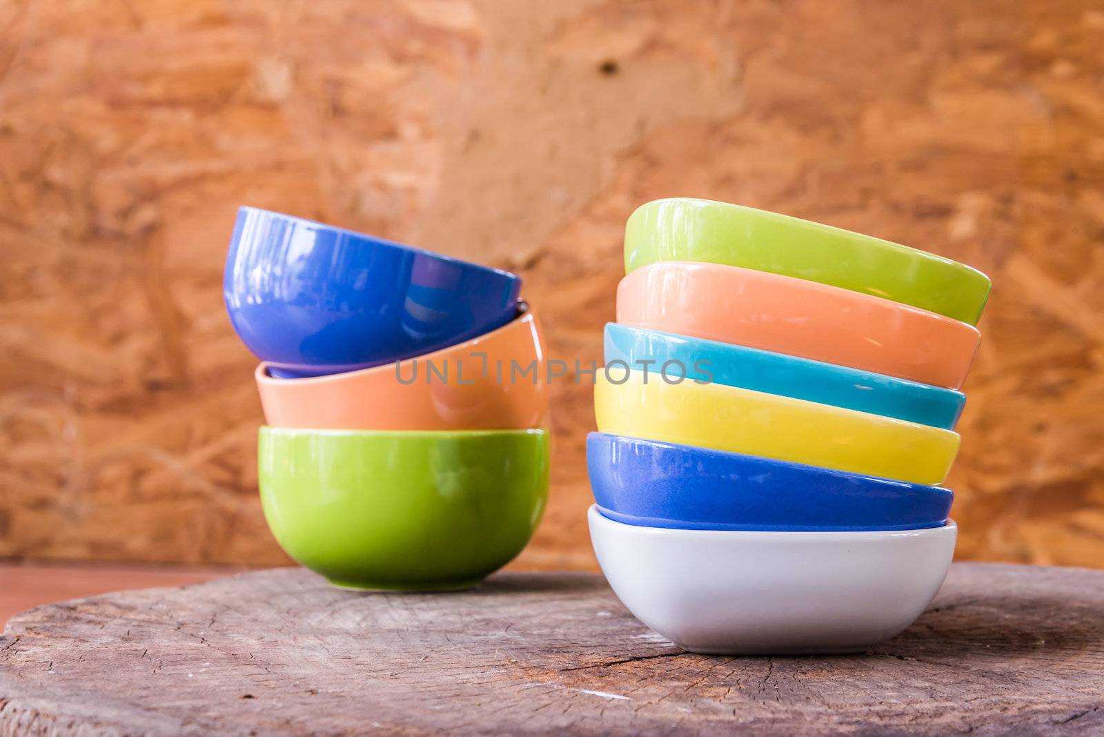Beautiful color cups on wood background by wmitrmatr
