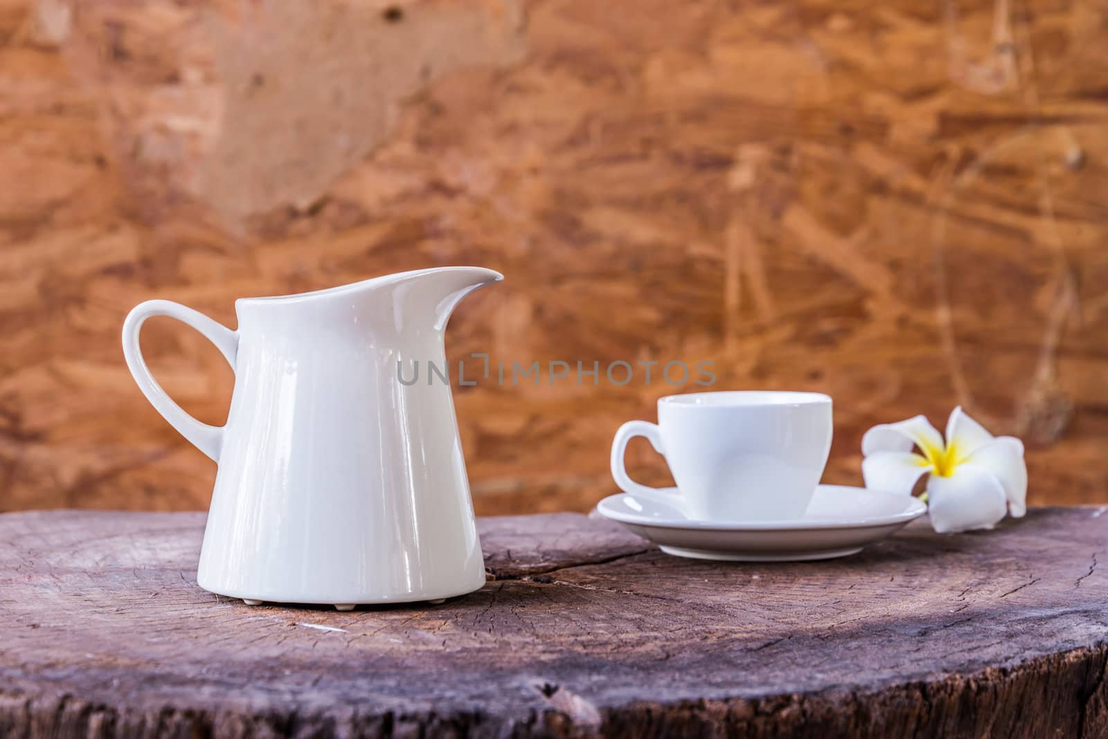 White cup with white tea pot on wood background by wmitrmatr
