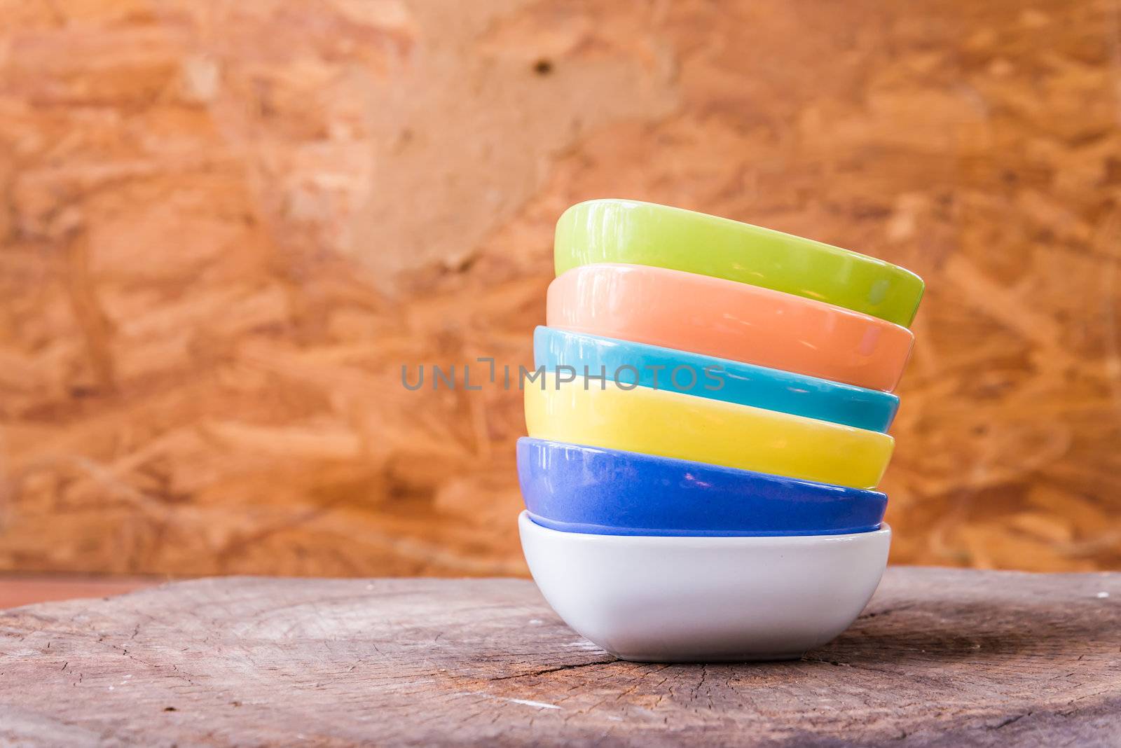 Beautiful color cups on wood background