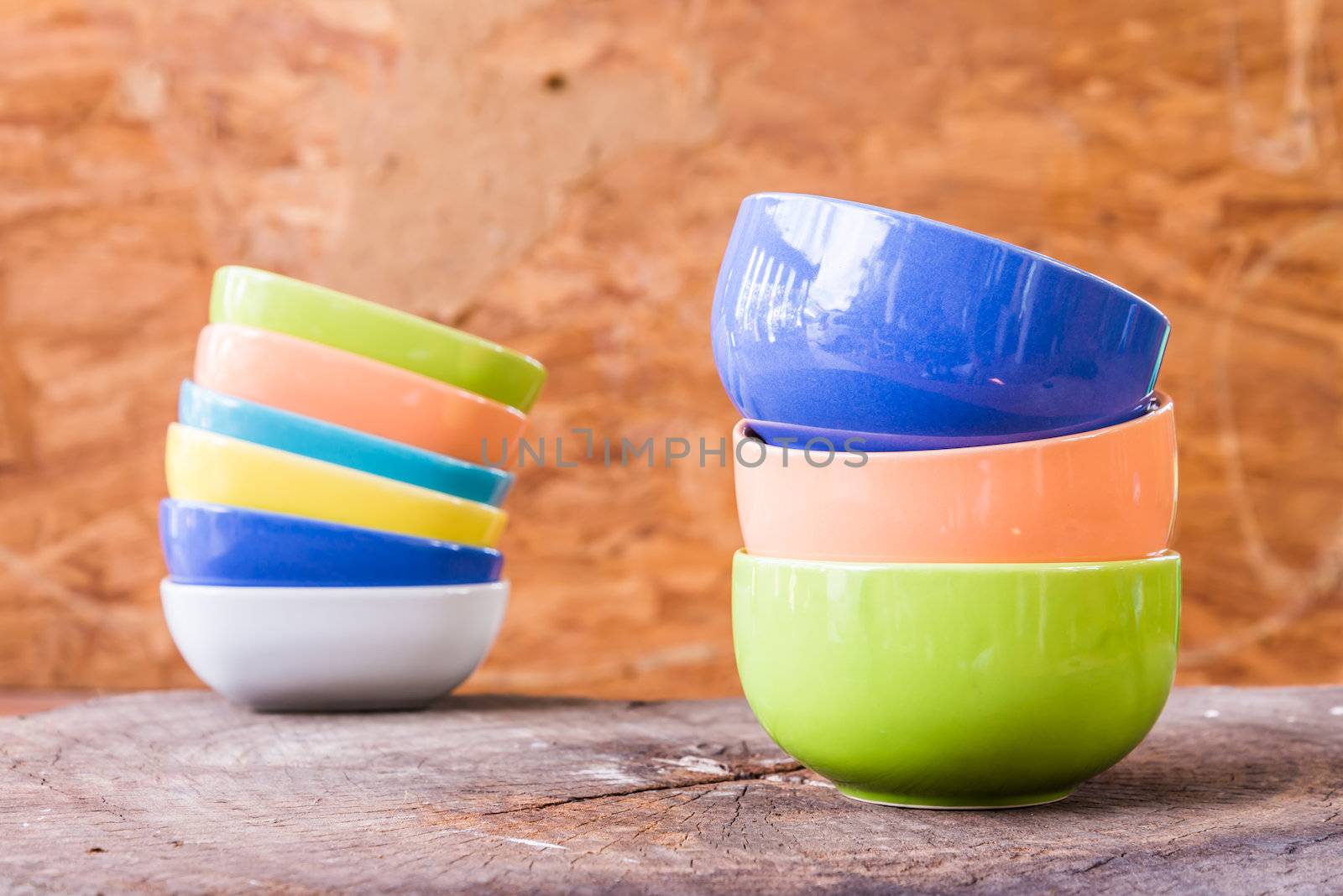 Beautiful color cups on wood background