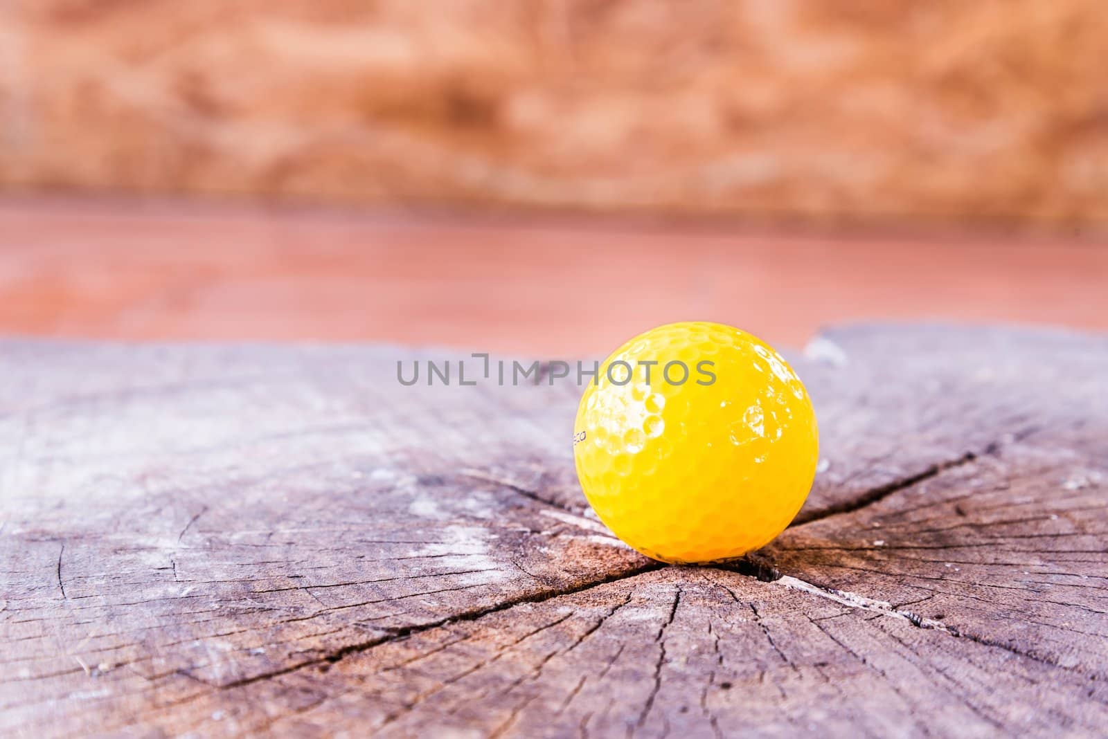 Yellow Miniature Golf Ball On White Background. by wmitrmatr