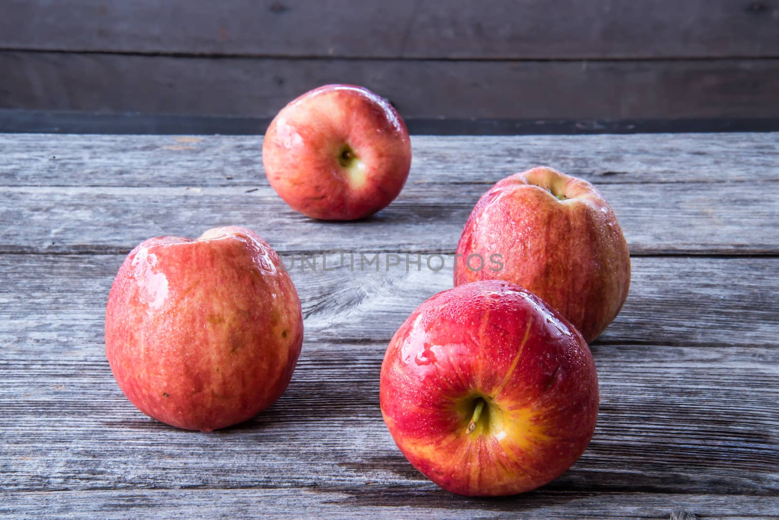 Red apple isolated on wood background