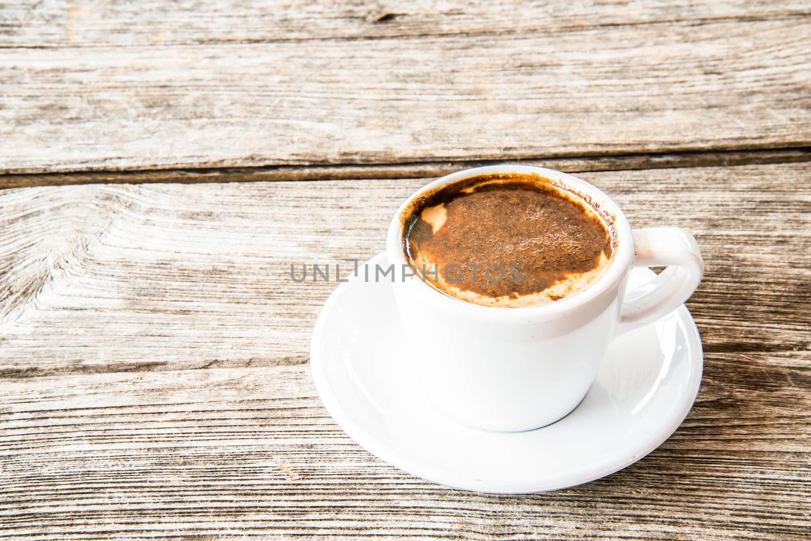hot coffee cup on wooden table on brown background