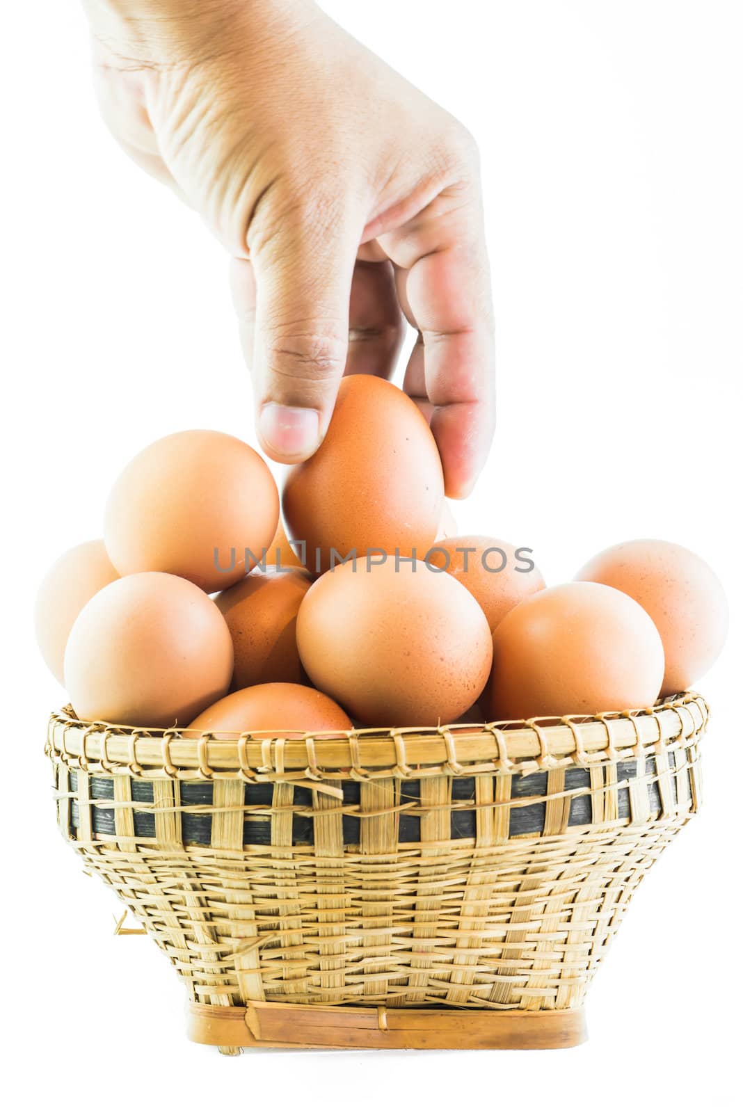 Brown eggs in the basket on white.