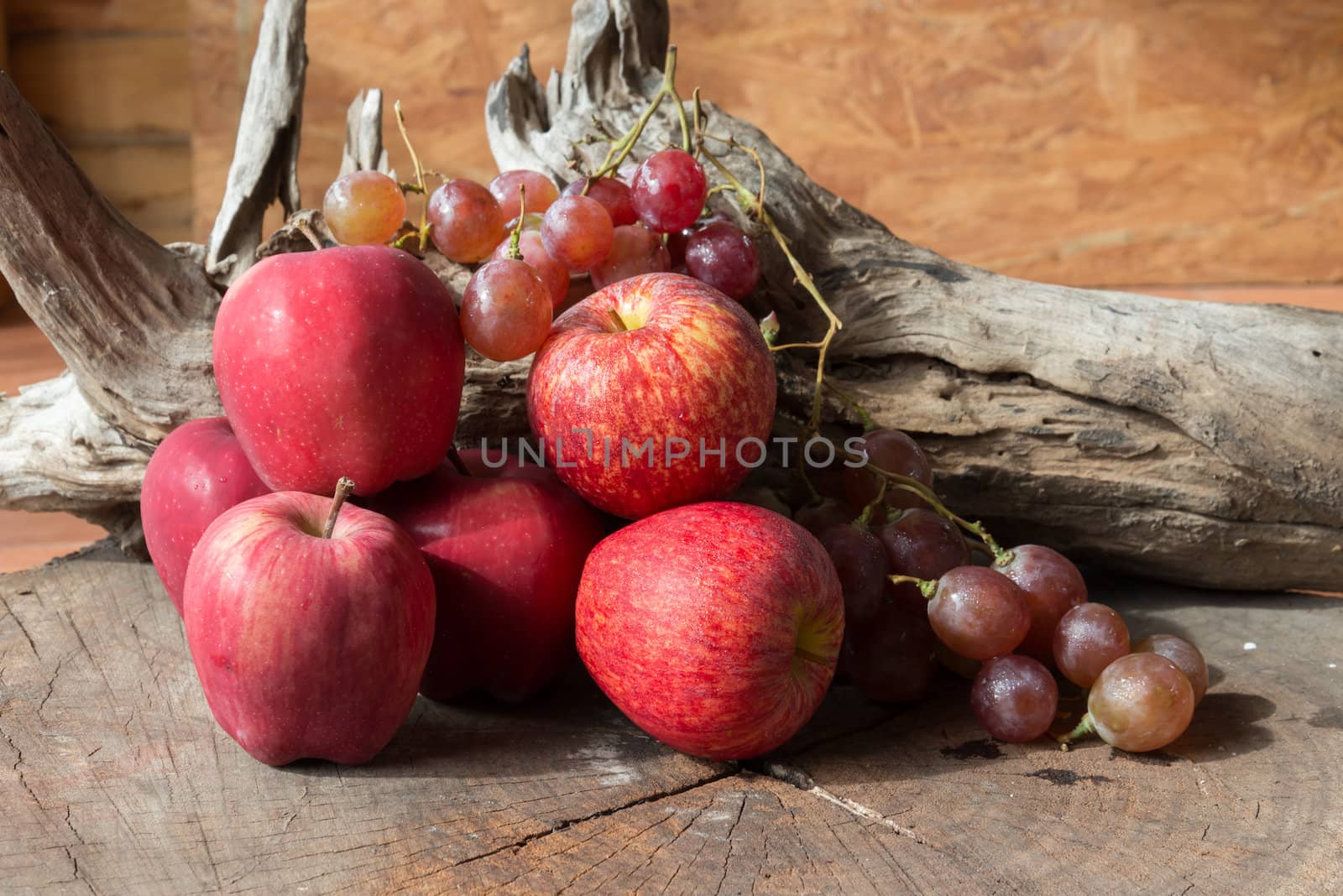 Still life red apples and grapes on old wood.