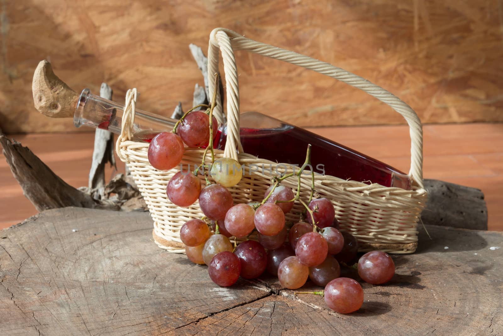 Wine and grapes on old wood.