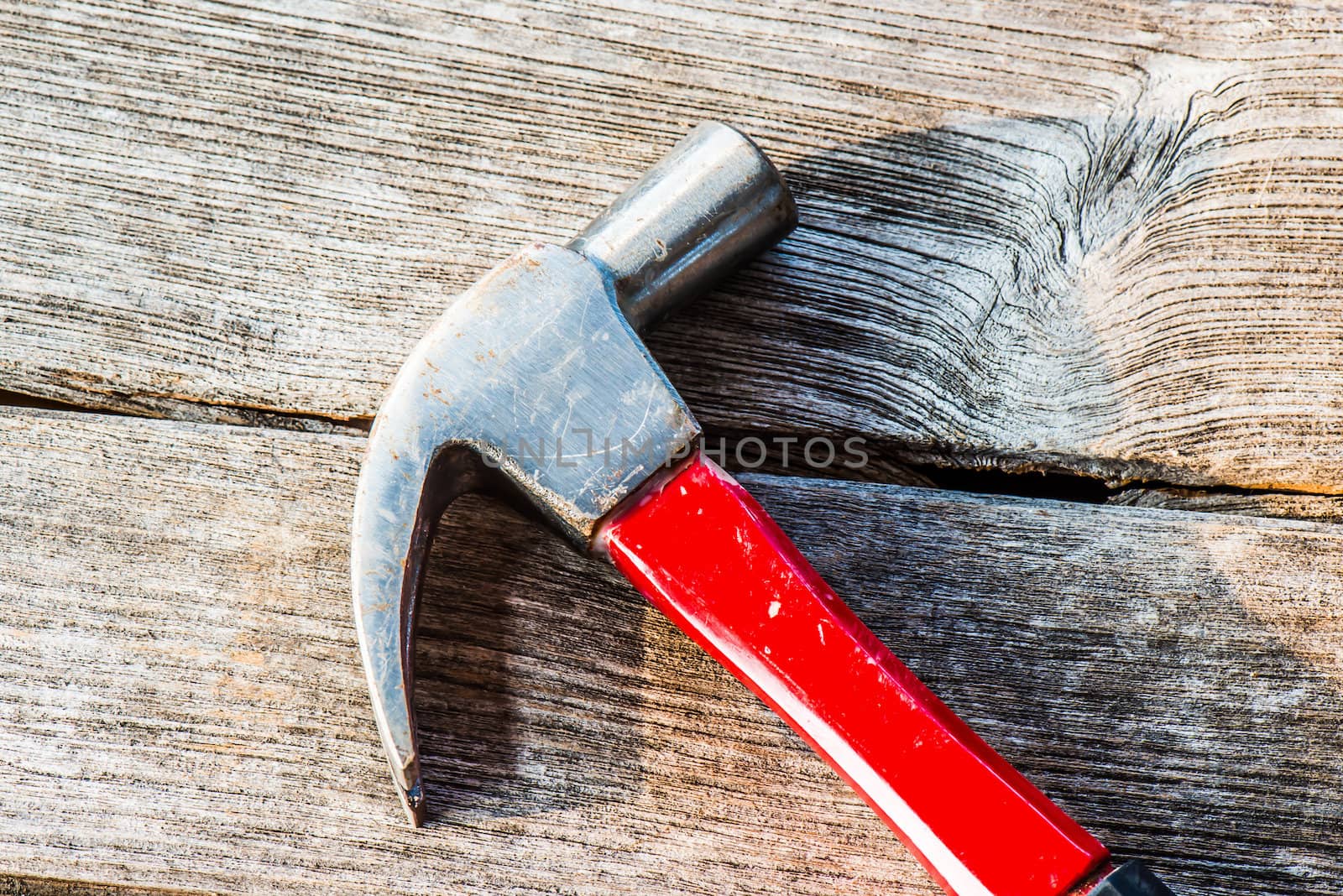 Hammer on a old wooden table top. Industrial tool.