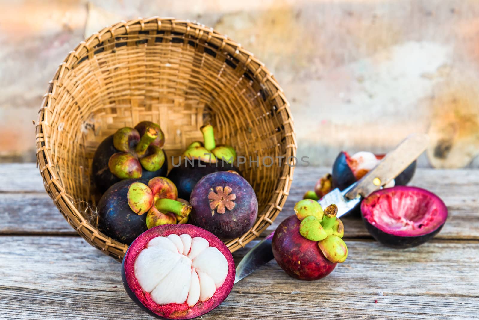 Mangosteen on bamboo tray put on wooden.