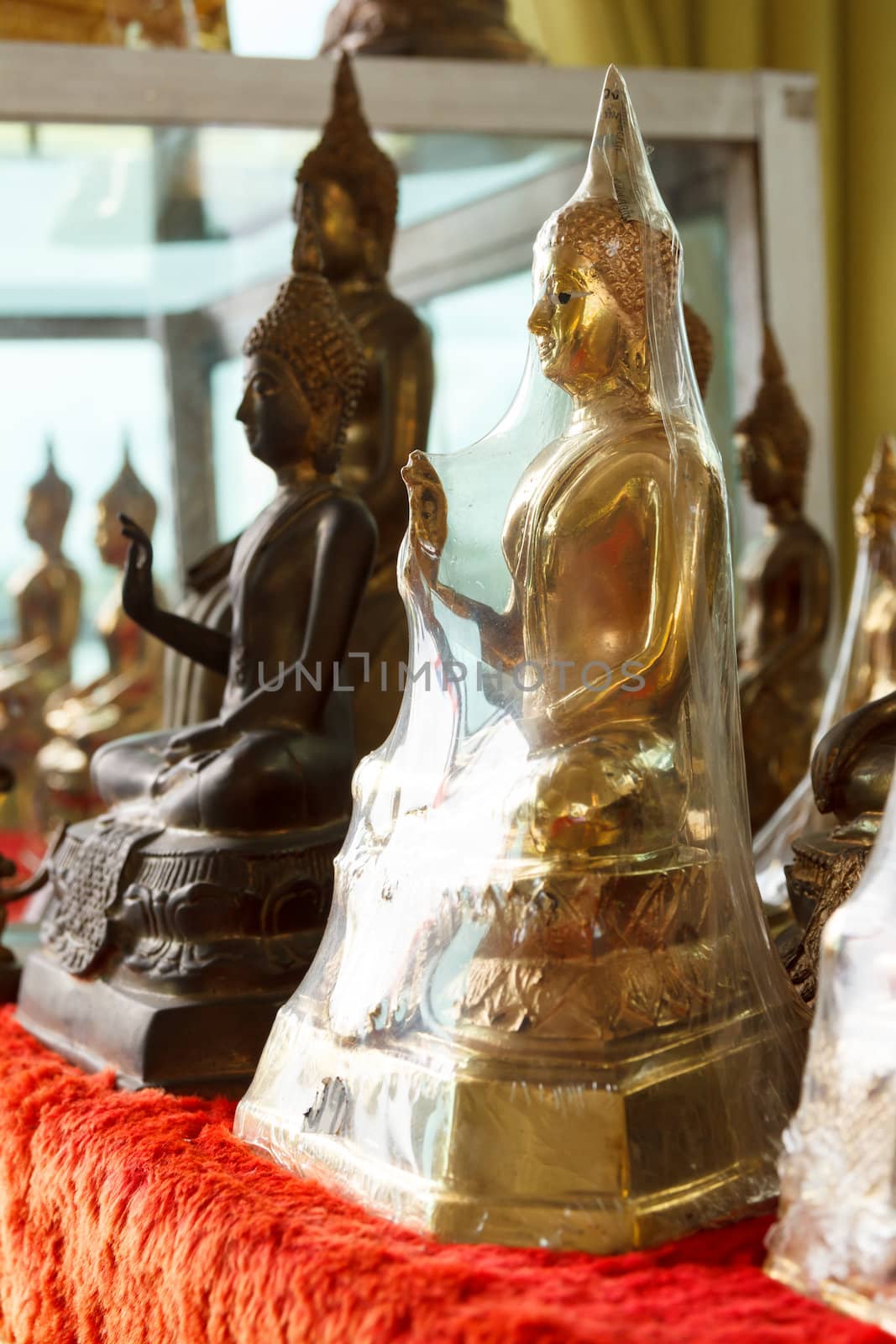 Buddha statues in plastic wrap by vitawin