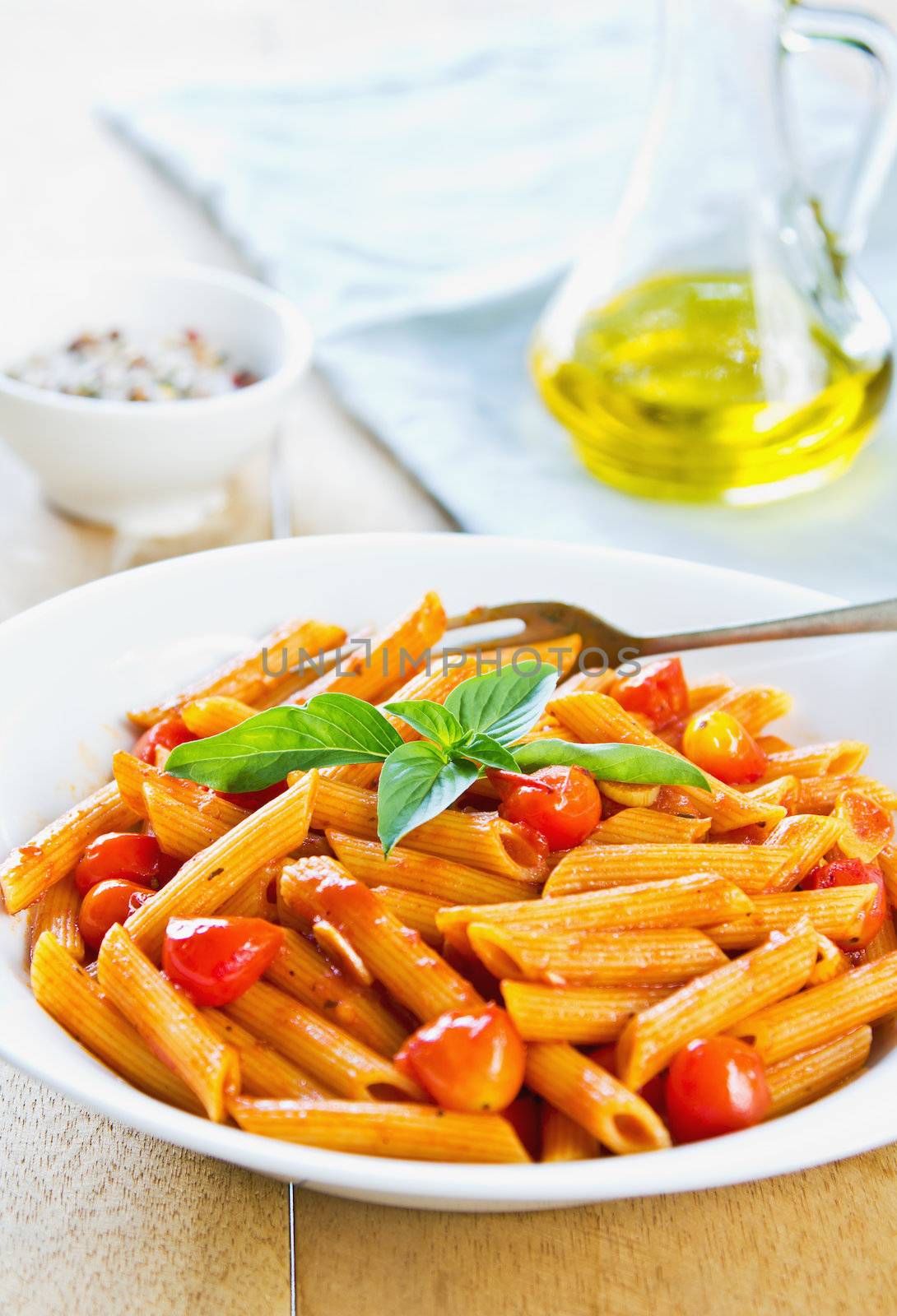 Penne in tomto sauce with basil  on top