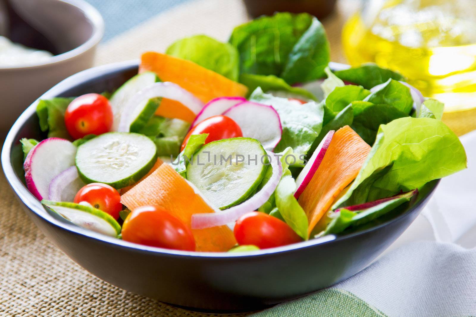 Fresh salad in a bowl by yogurt dressing