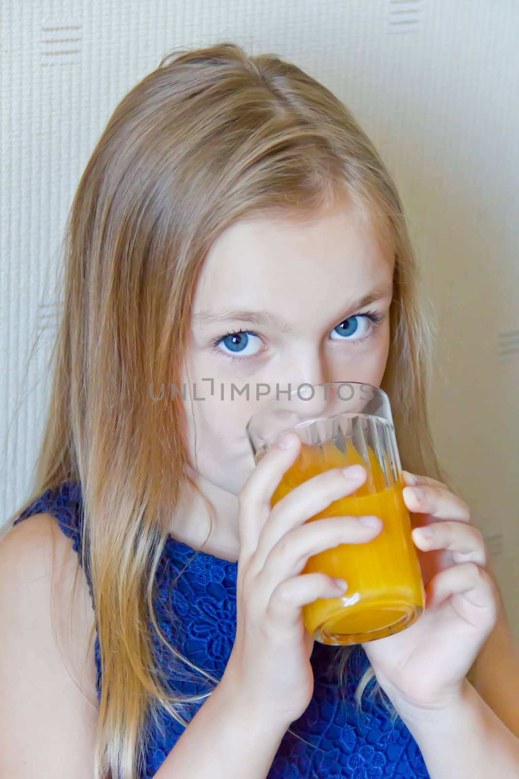 Cute girl with blond long hair drinking beverage
