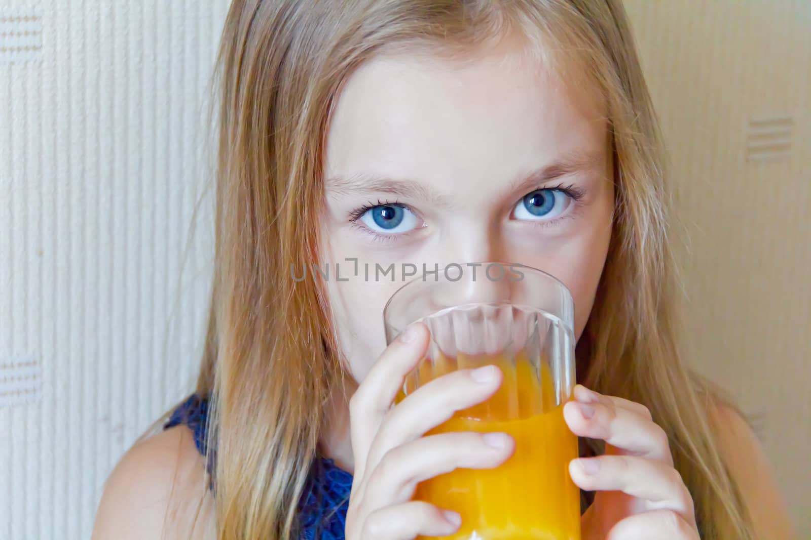 Cute girl with blond long hair drinking beverage